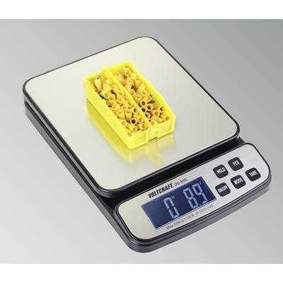 Eine Digitalwaage zeigt ein Gewicht von 89 Gramm, auf der Waage liegt eine gelbe Box mit gelben Steckverbindern.
