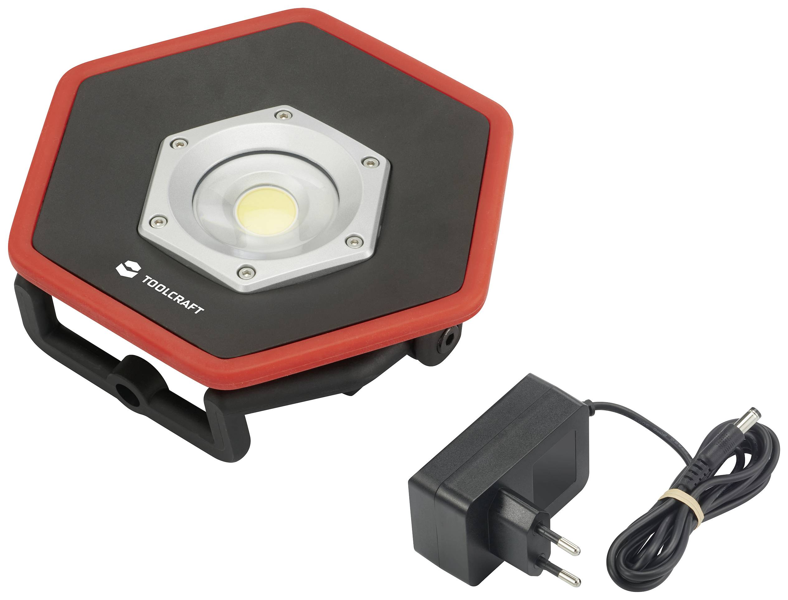 LED-Arbeitsleuchte mit sechseckigem Gehäuse, in rot-schwarz, inklusive Netzteil. Markenlogo zu erkennen.