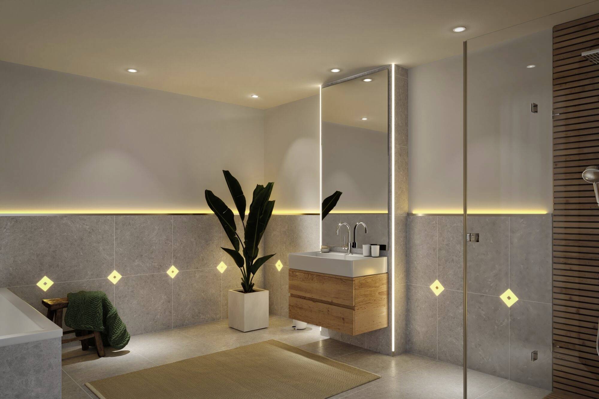 Modernes Badezimmer mit warmem Licht, einer großen Pflanze, Waschbecken mit beleuchtetem Spiegel, grauen Fliesen und Holzakzenten.