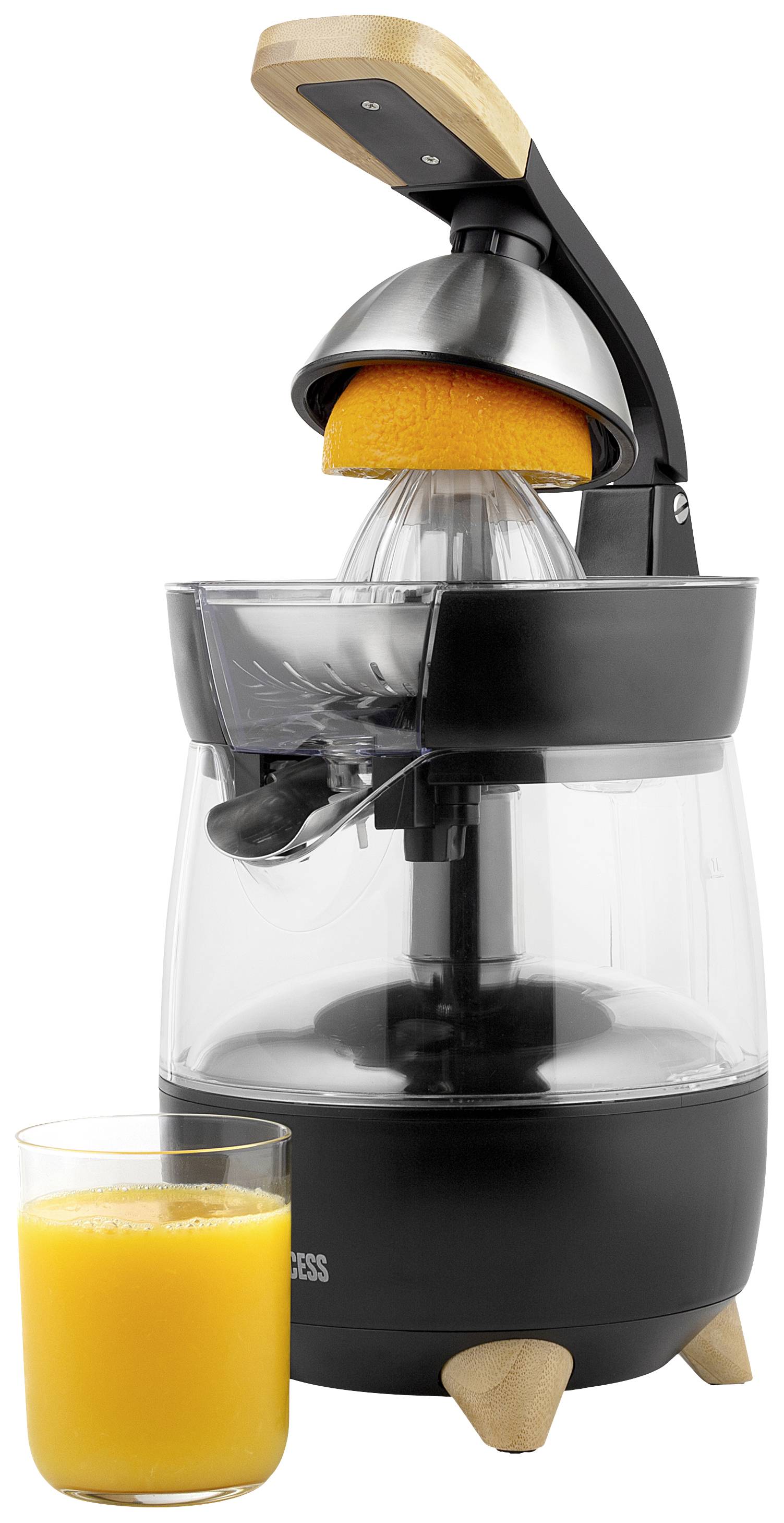 Elektrische Saftpresse mit schwarzem Gehäuse presst eine halbe Orange. Vorne steht ein Glas mit frisch gepresstem Orangensaft.