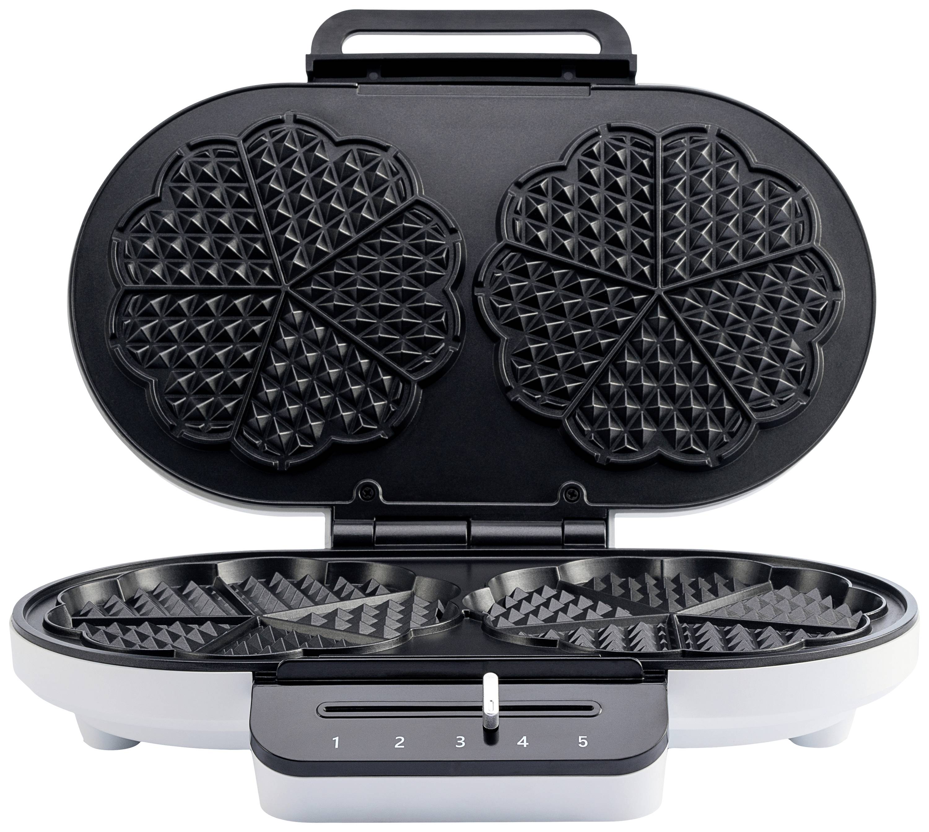 Ein geöffneter Waffeleisen mit zwei herzförmigen Platten und einem Drehregler mit Skala von 1 bis 5 zeigt die Wärmeeinstellung.