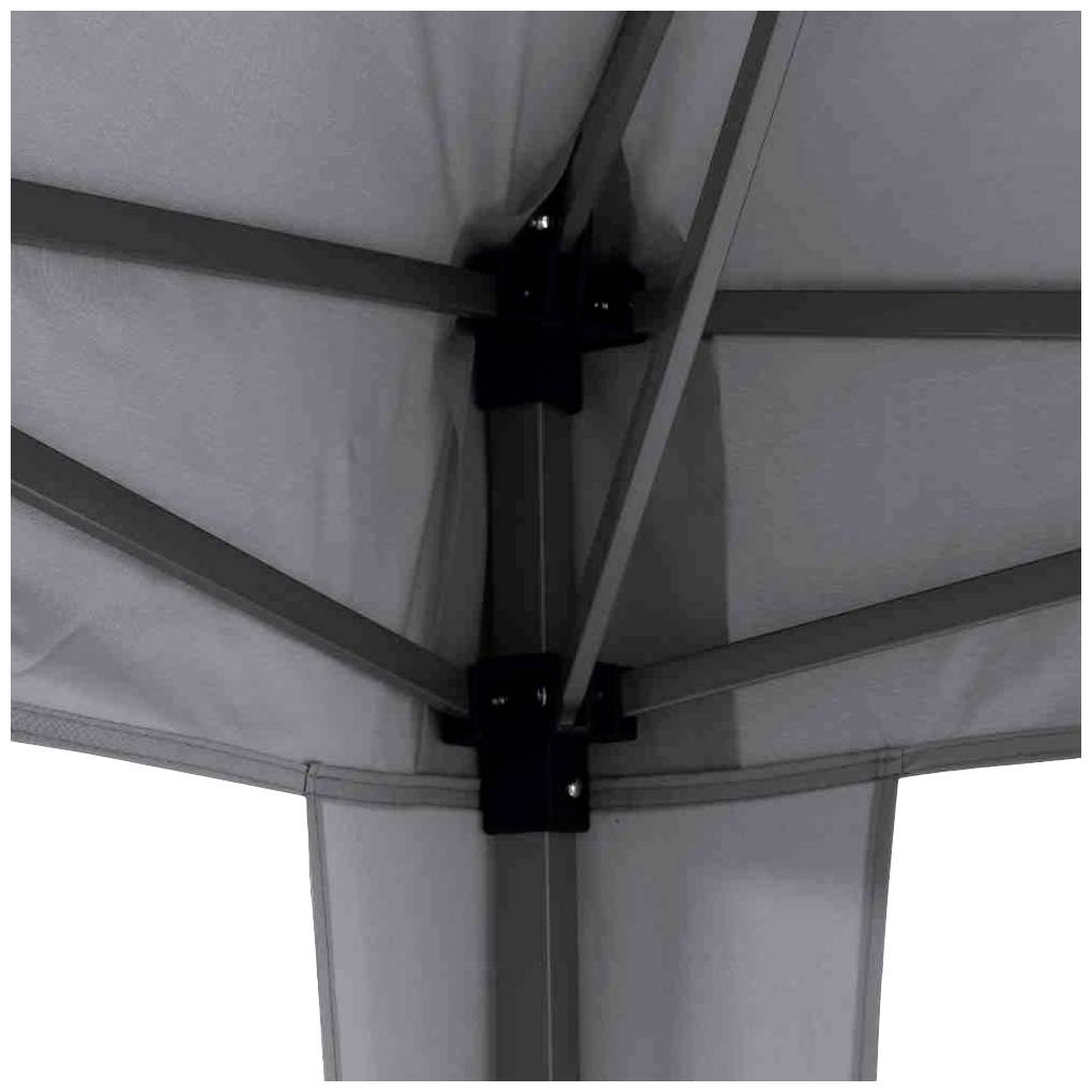 Detailaufnahme der Unterseite eines grauen Sonnenschirms mit sichtbaren Metallstreben und Verbindungsstücken.