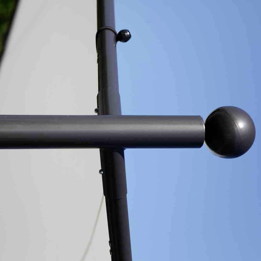Ein schwarzer Fahnenmast mit einem Kugelabschluss oben vor blauem Himmel und einem weißen Hintergrund auf der linken Seite.