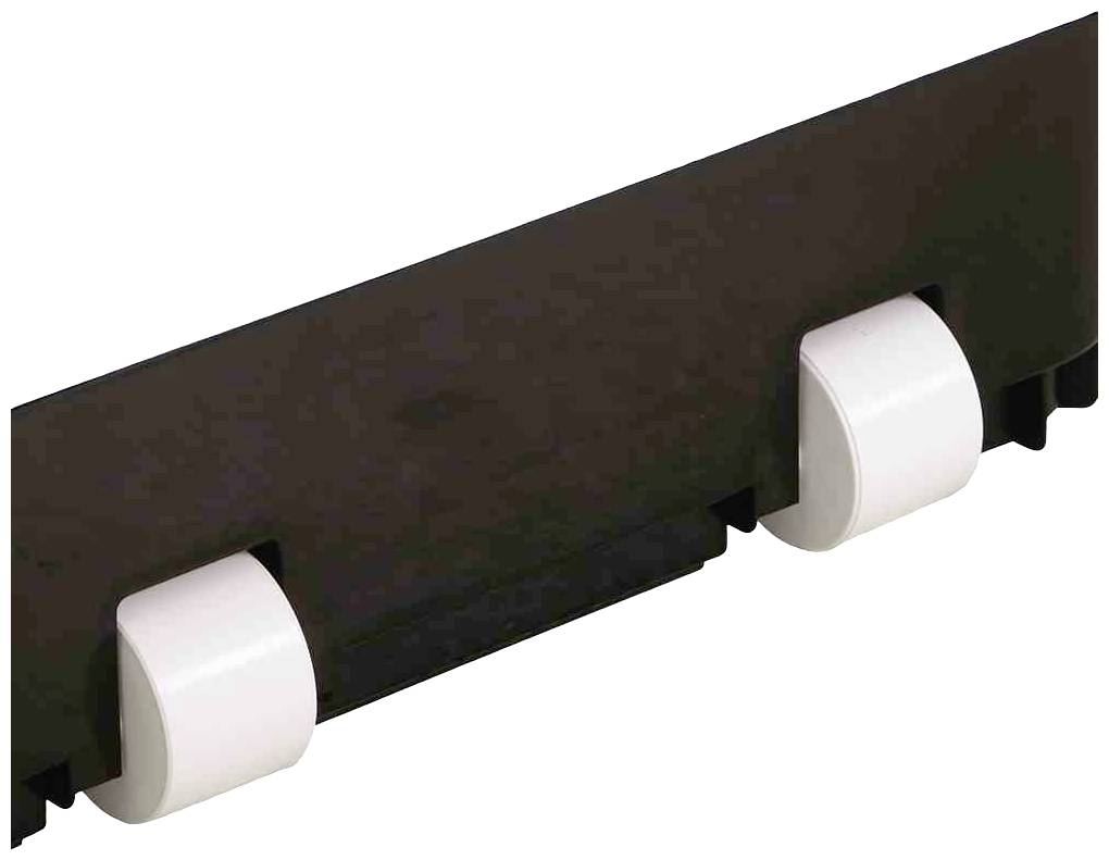 Schwarzes Bauteil mit zwei weißen, runden Befestigungen an einer Seite.