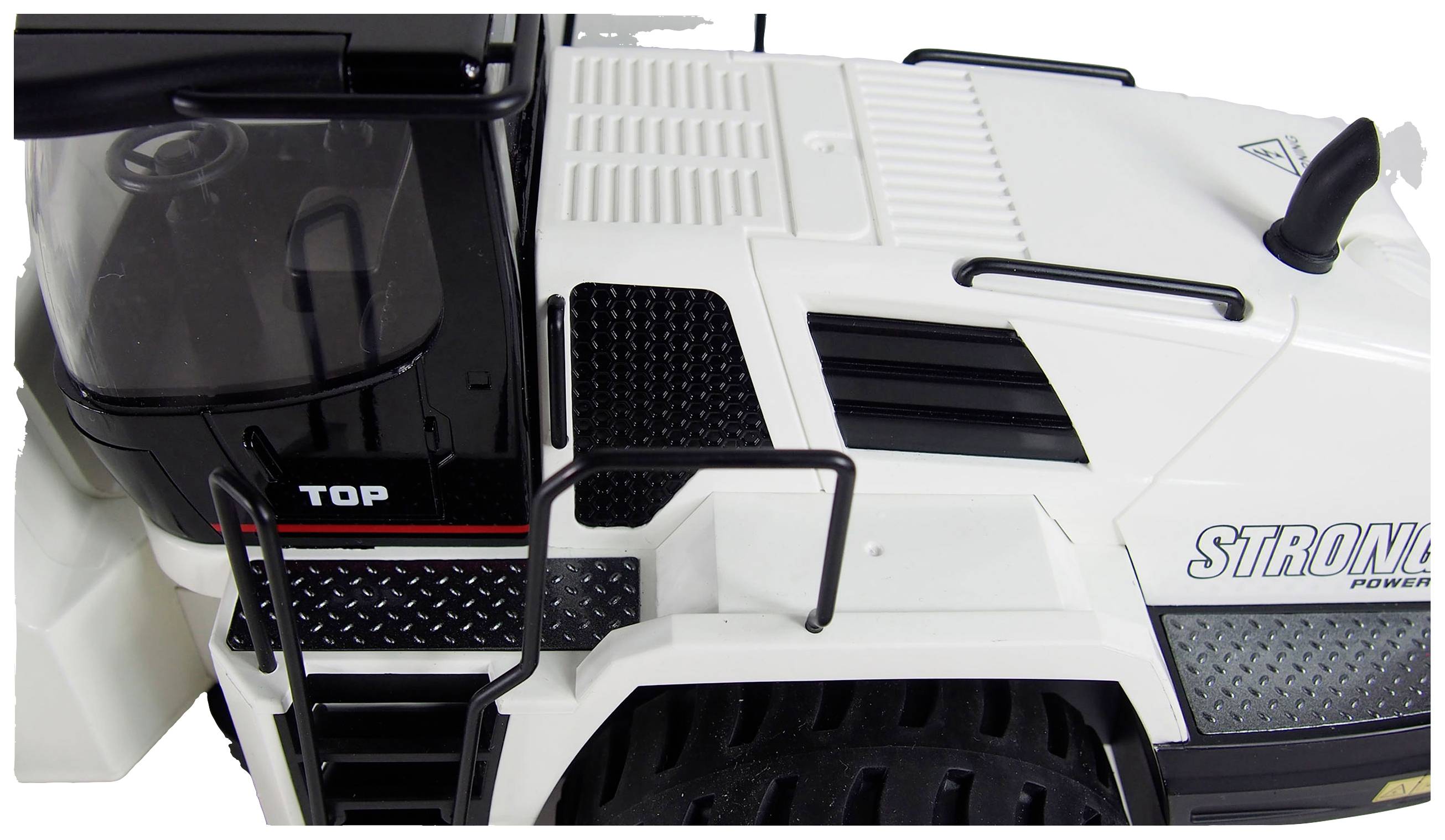 Weißes und schwarzes Modellfahrzeug mit Aufschrift 'STRONG', Nahaufnahme der Fahrerkabine und Details der Karosserie.