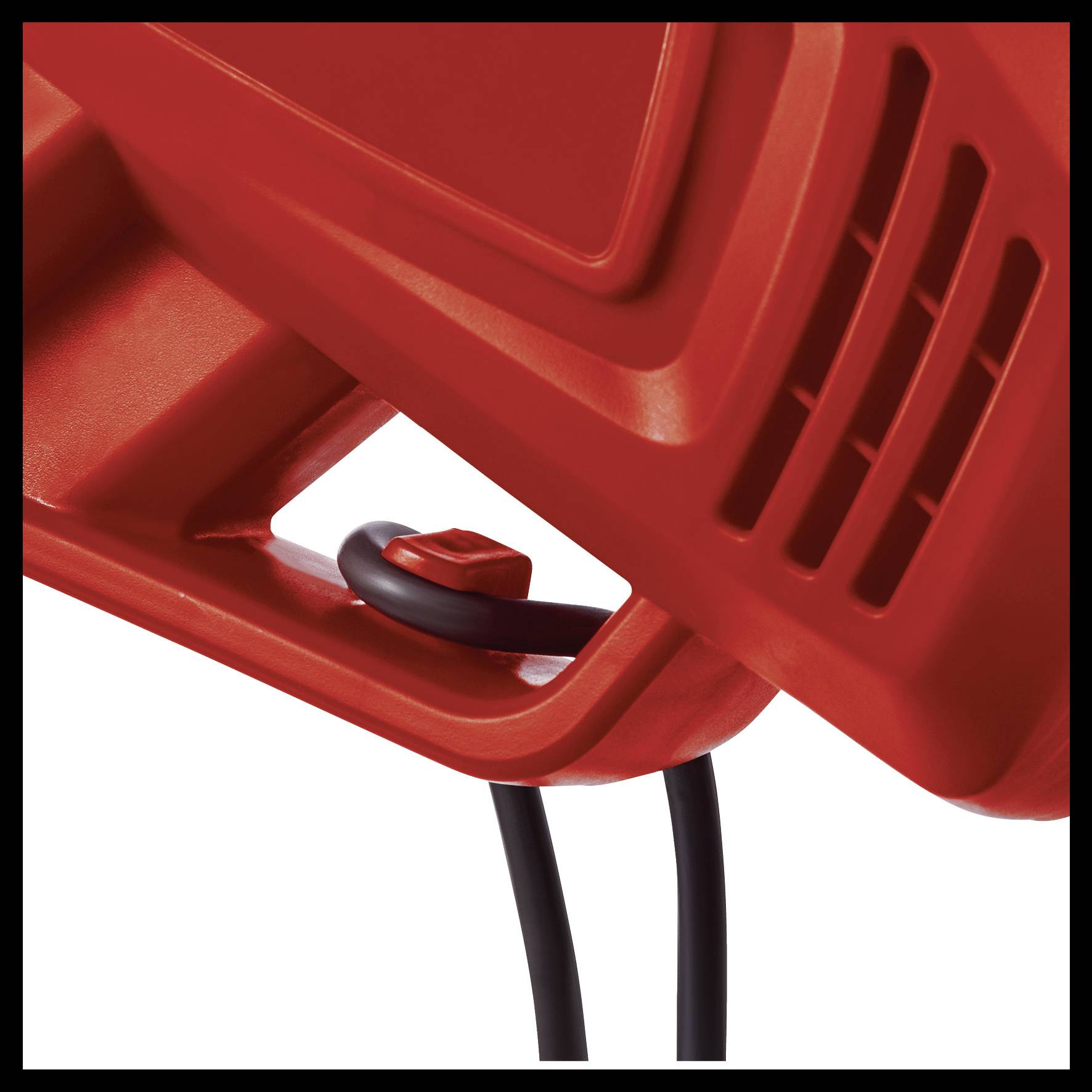 Nahaufnahme eines roten Kunststoffgeräts mit Belüftungsschlitzen und schwarzem Kabel.