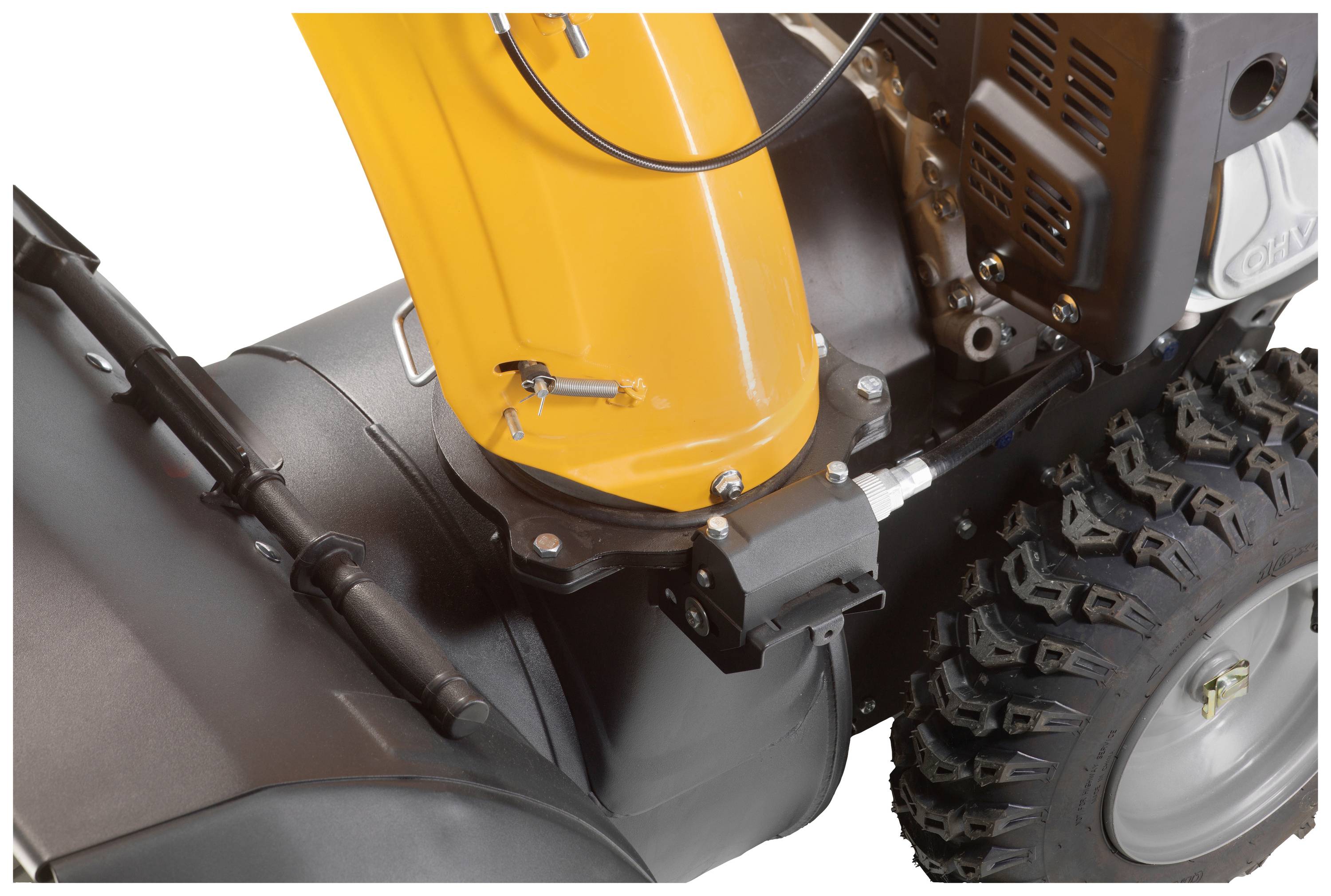 'Nahaufnahme eines Schneefräsenrades und eines orangefarbenen Gehäuses mit schwarzem Antriebsteil und grobstolligem Reifenprofil.'