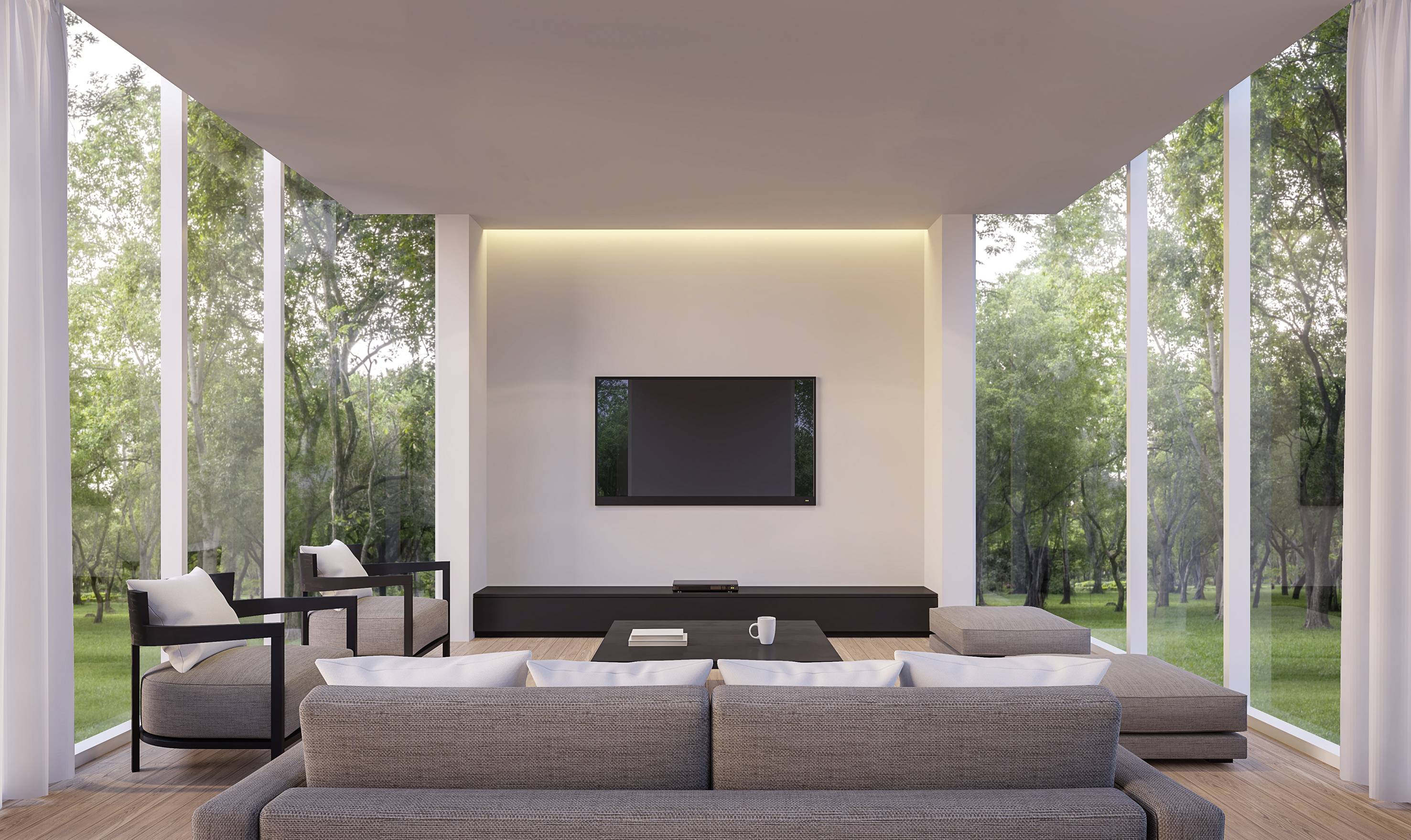 Modernes Wohnzimmer mit großen Glasfenstern, grauen Sofas, einem Flachbildfernseher an der Wand und Blick auf einen grünen Garten.