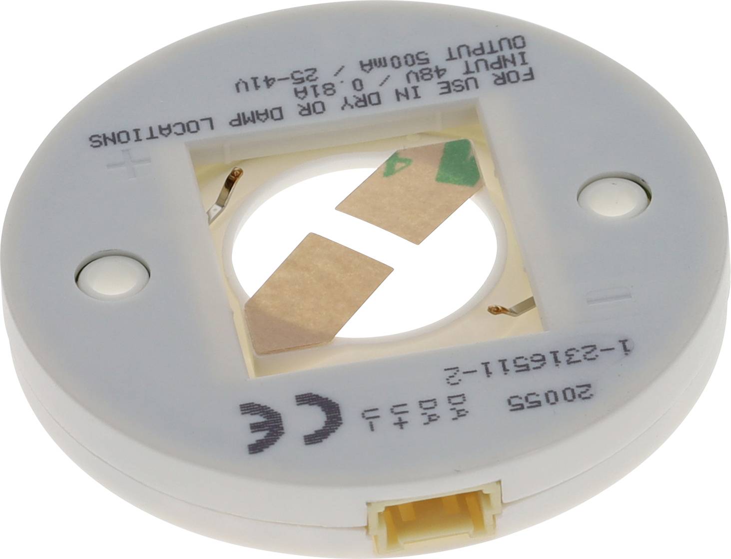 Runde elektronische Komponente mit beschrifteten Anschlüssen, verwendet für Verdrahtungsanwendungen. Gekennzeichnet mit 'Eingangsspannung 690V - 0,6/1kV' und 'Zur Verwendung in trockenen oder feuchten Umgebungen.'