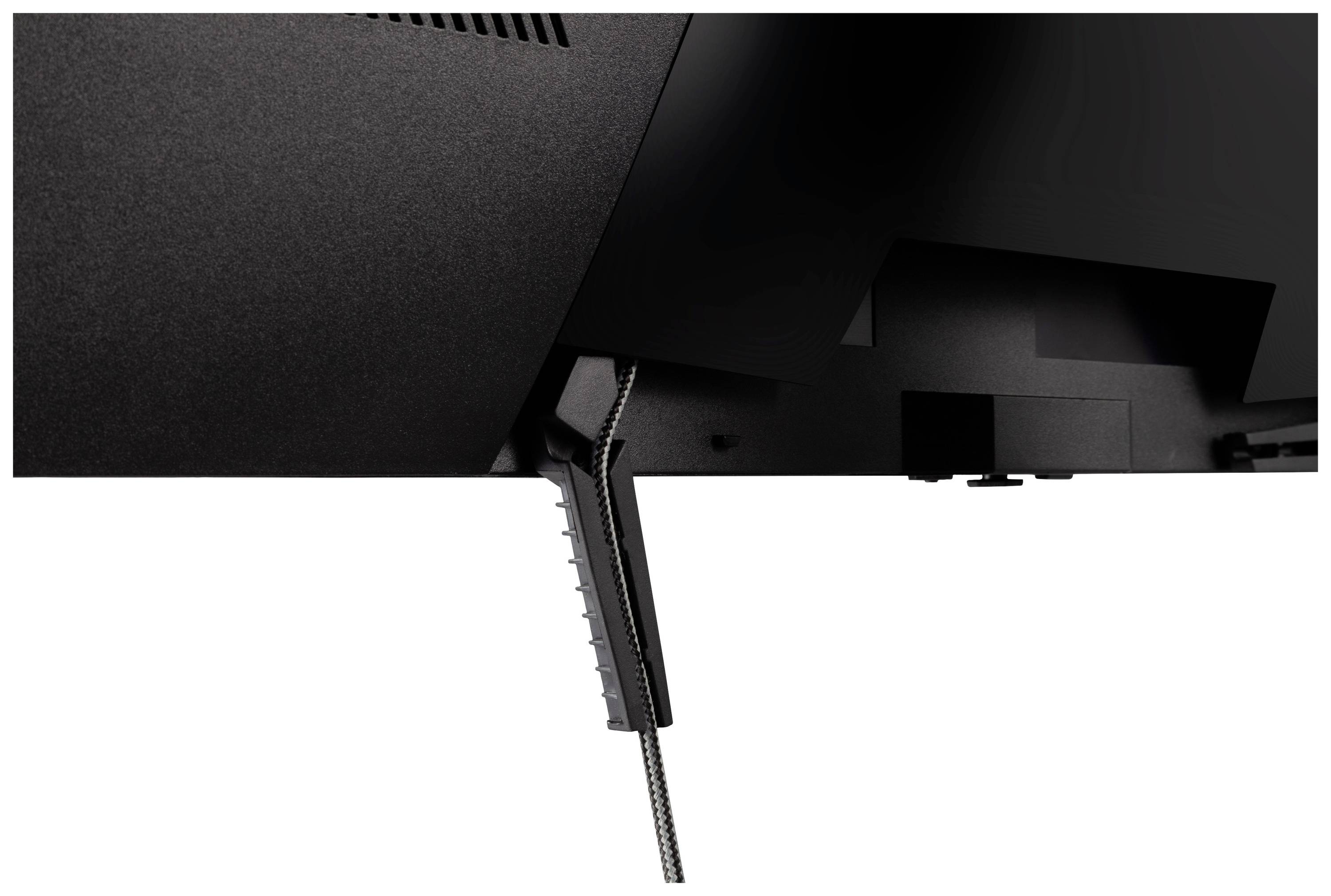 Nahaufnahme der Rückseite eines schwarzen Computermonitors mit sichtbaren Lüftungsschlitzen und einem Ständer.