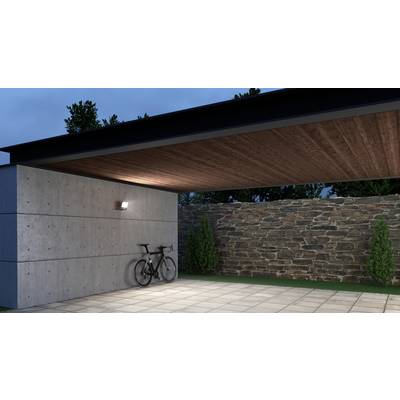 Moderner Carport mit Betonwänden, Holzdach und Steinmauer im Hintergrund; ein Fahrrad steht an der Betonwand.