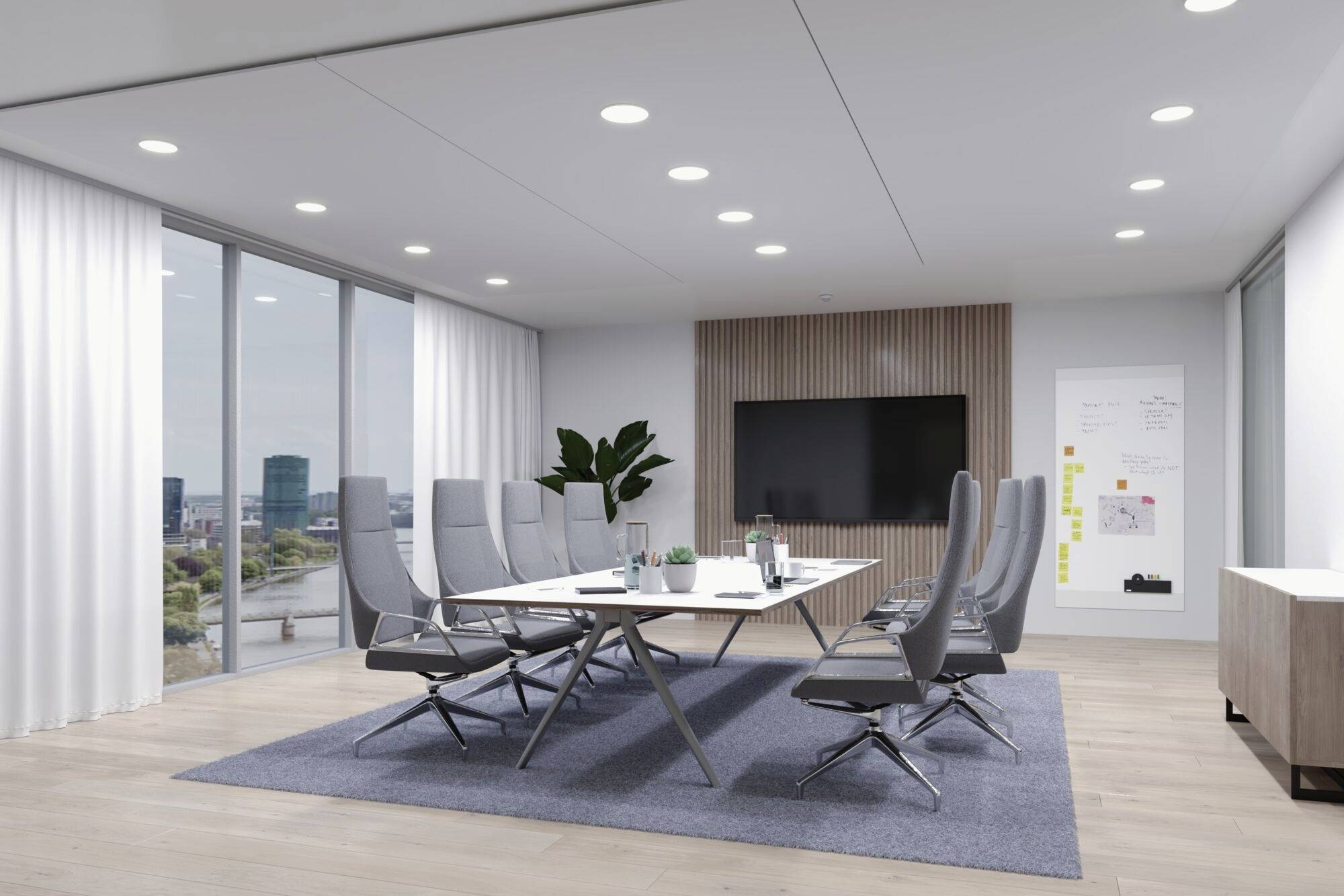 Konferenzraum mit großem Tisch, modernen Stühlen, einem Bildschirm an der Wand und Fenstern mit Stadtblick. Helle, minimalistische Einrichtung.