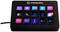 Ein schwarzes Stream-Deck mit 15 bunten Tasten, jede mit einem Symbol oder Text wie 'Multi Action' und 'Timer'. Verwendet für einfache Steuerung.