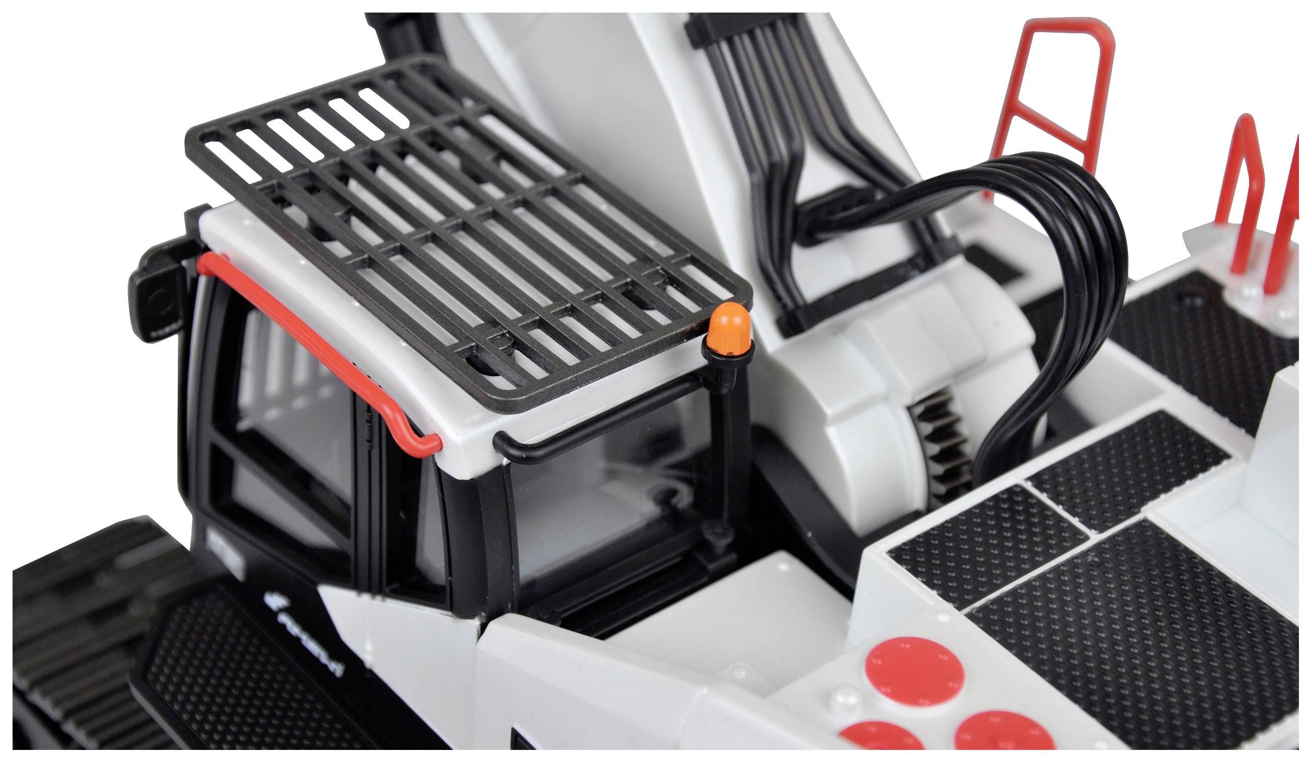 Ein Spielzeug-Mobilkran aus Kunststoff mit schwarzer und weißer Lackierung. Das Führerhaus hat rote Details und eine orange Warnleuchte.