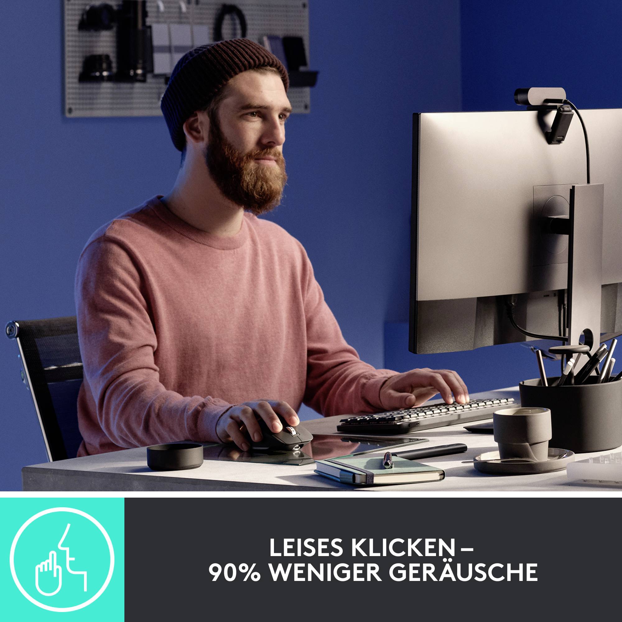 Ein Mann am Schreibtisch benutzt einen Computer. Text am Bildrand: 'Leises Klicken – 90% weniger Geräusche'.