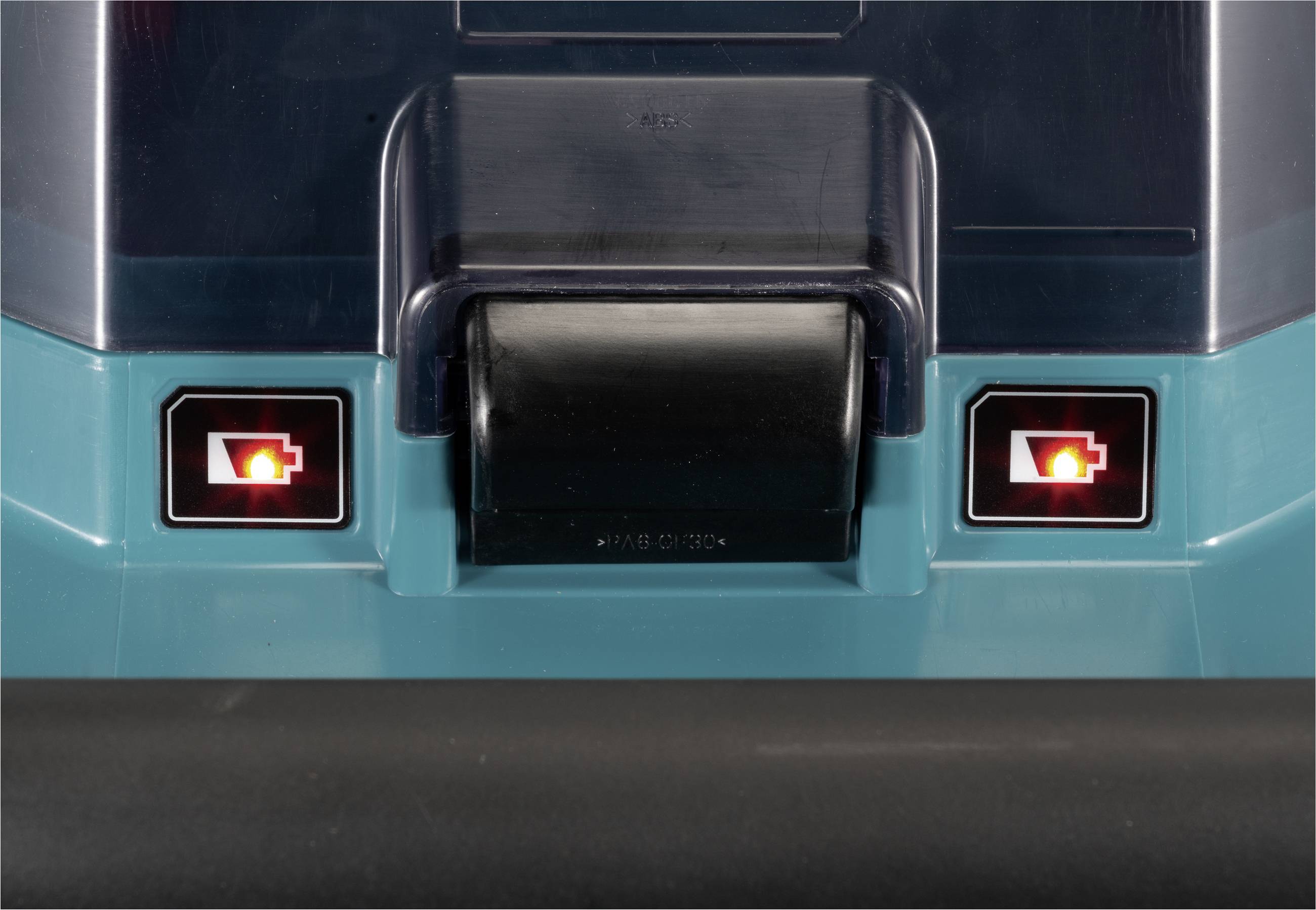 Zwei rote Lichter neben einer schwarzen Walze an einer Maschine. Die Lichter symbolisieren den Batteriestand.