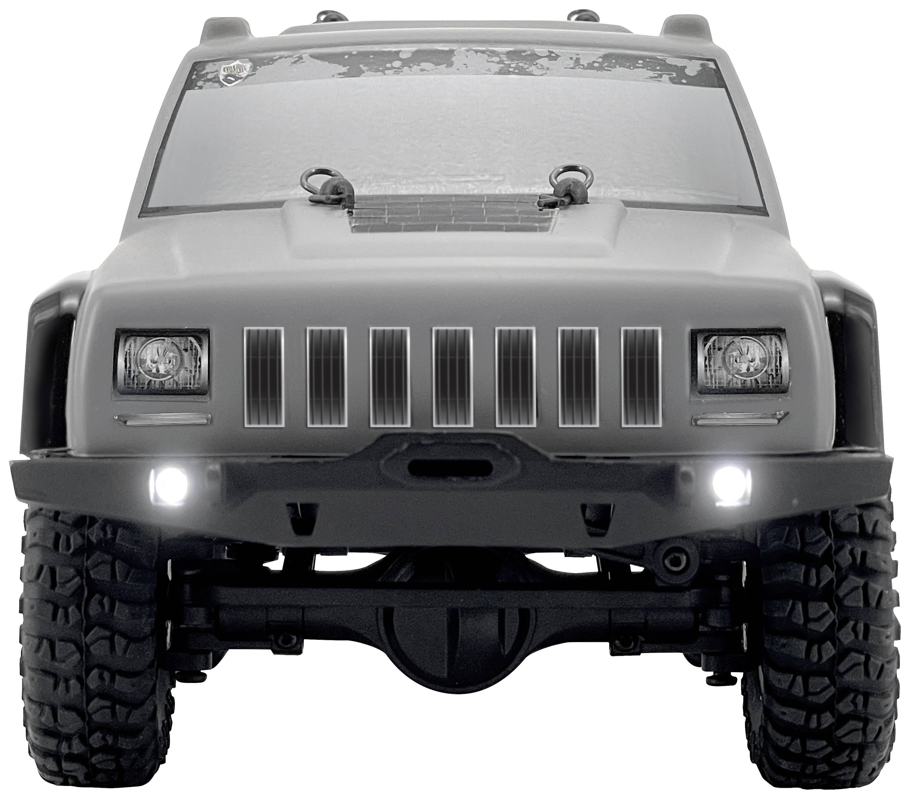 Graues, frontales Auto mit markanten Scheinwerfern und Geländereifen. Es hat einen robusten, abenteuerlichen Look.