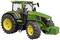 Ein grüner Traktor mit gelben Rädern und einer großen Fahrerkabine.