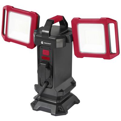 Zwei LED-Strahler mit roten Rahmen, die auf einem zentralen schwarzen Sockel montiert sind. Tragegriff und Kabelanschluss vorhanden.