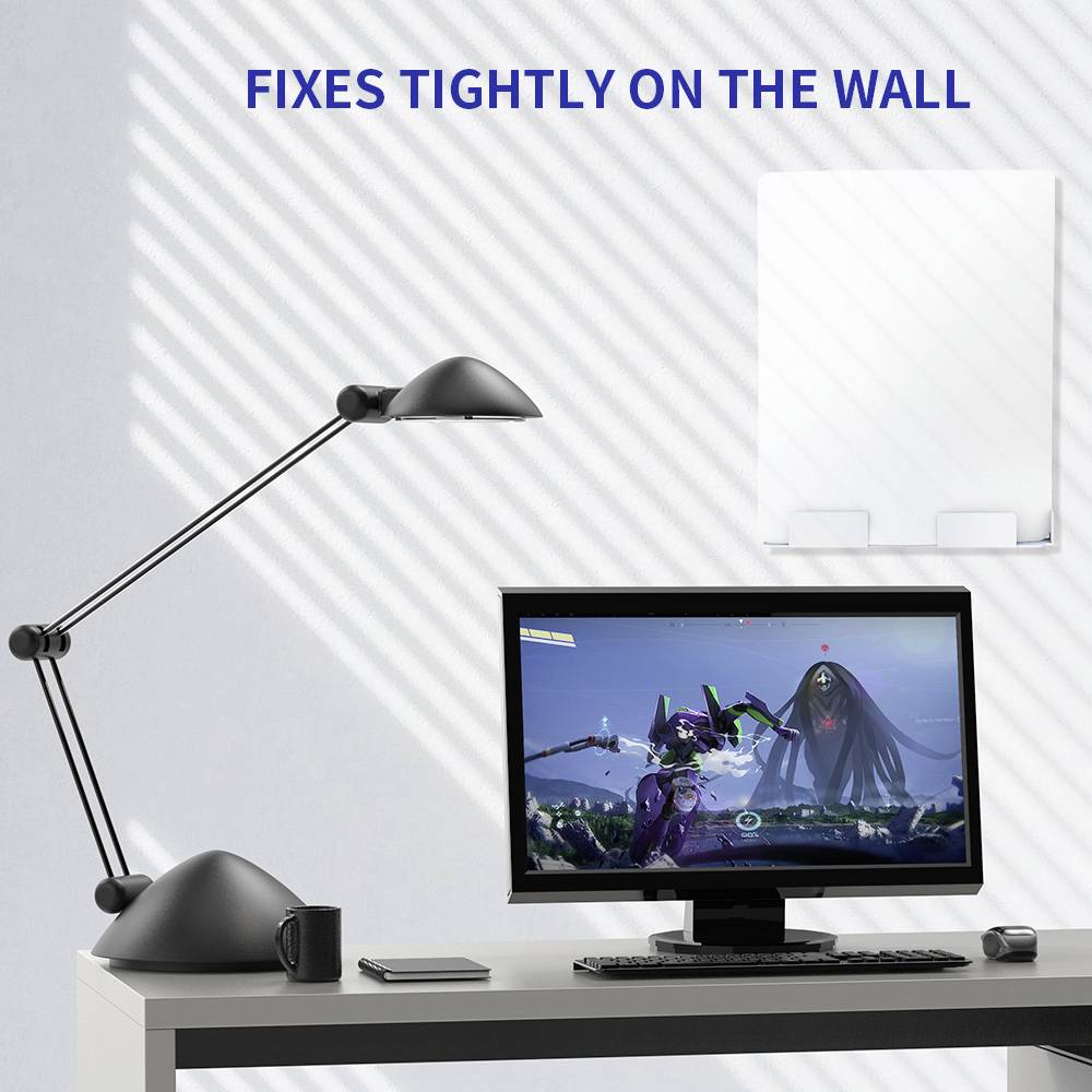 Ein Schreibtisch mit Lampe, Computer und Smartphone. An der Wand ein Spiegel und der Text 'Fixes tightly on the wall'.