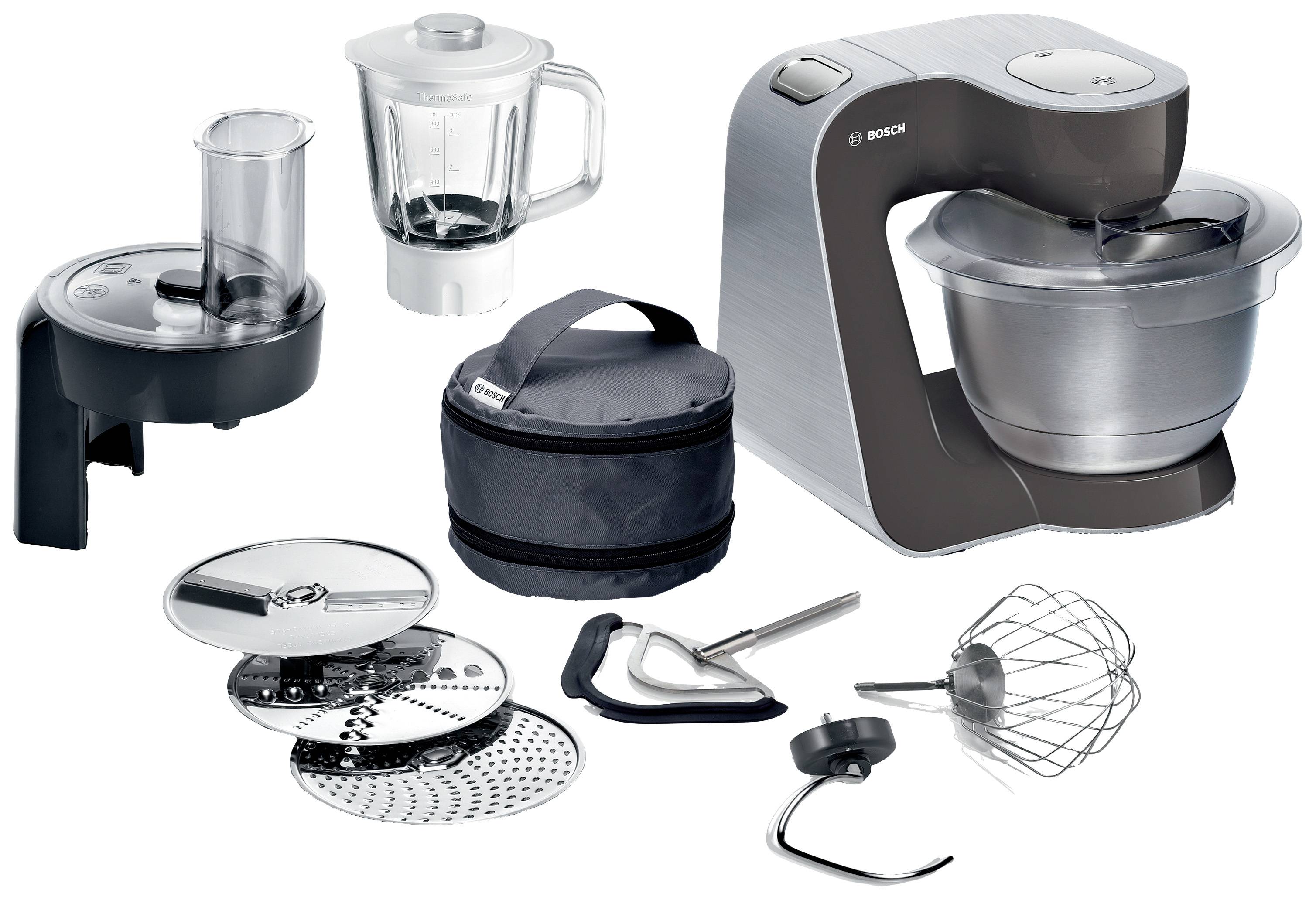 Eine Küchenmaschine mit Zubehör wie Mixer, Rührhaken, Dividerscheiben, Schneebesen und flexiblem Dämpfeinsatz.