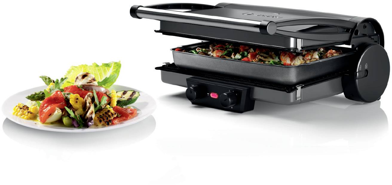 Ein Tischgrill mit geöffneter Grillplatte. Daneben ein Teller mit gegrilltem Gemüse und Salat. Ideal zum Zubereiten gesunder Mahlzeiten.