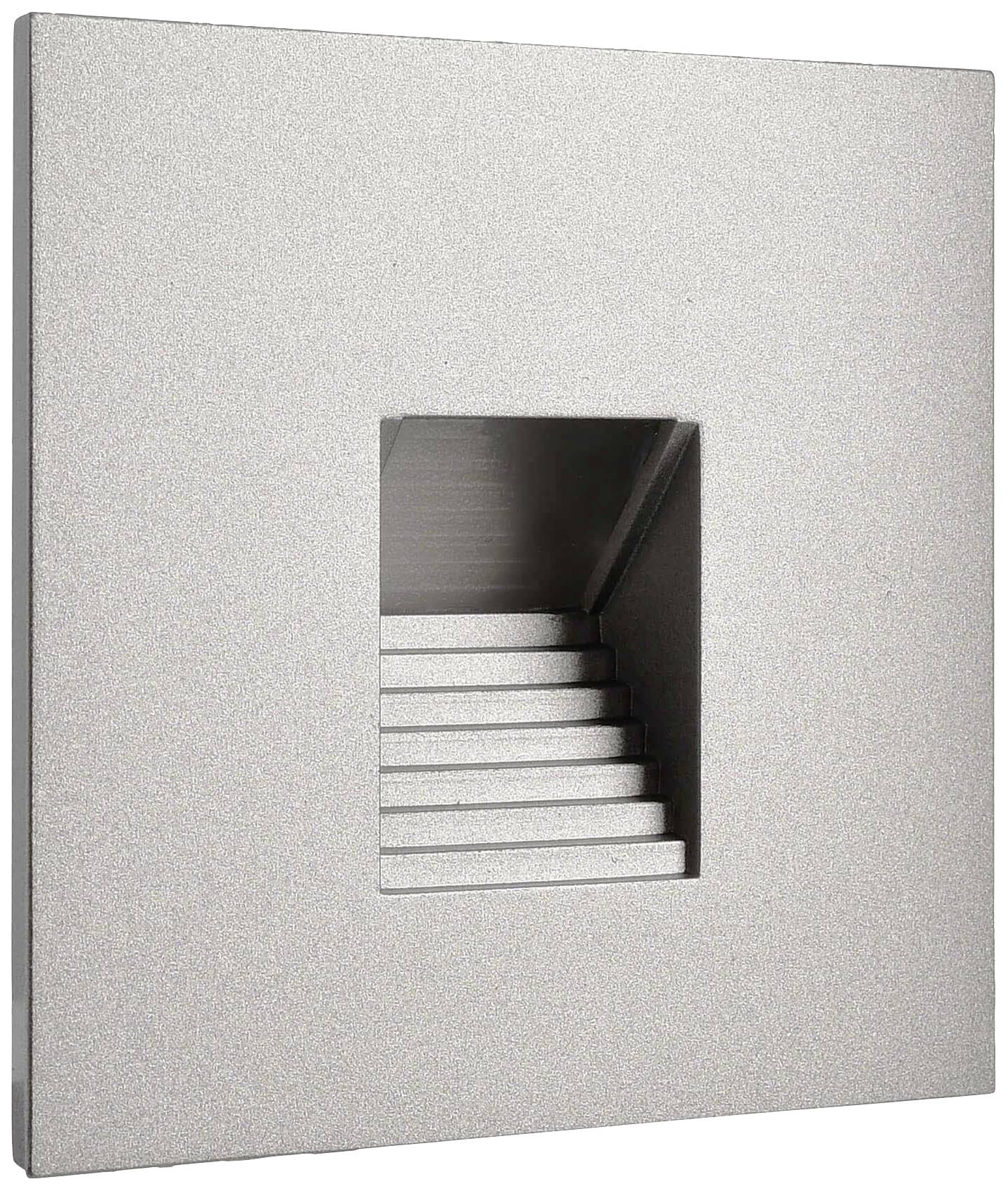 Metallische quadratische Platte mit einem zentrierten rechteckigen Ausschnitt. Dahinter sind kleine treppenartige Strukturen sichtbar.