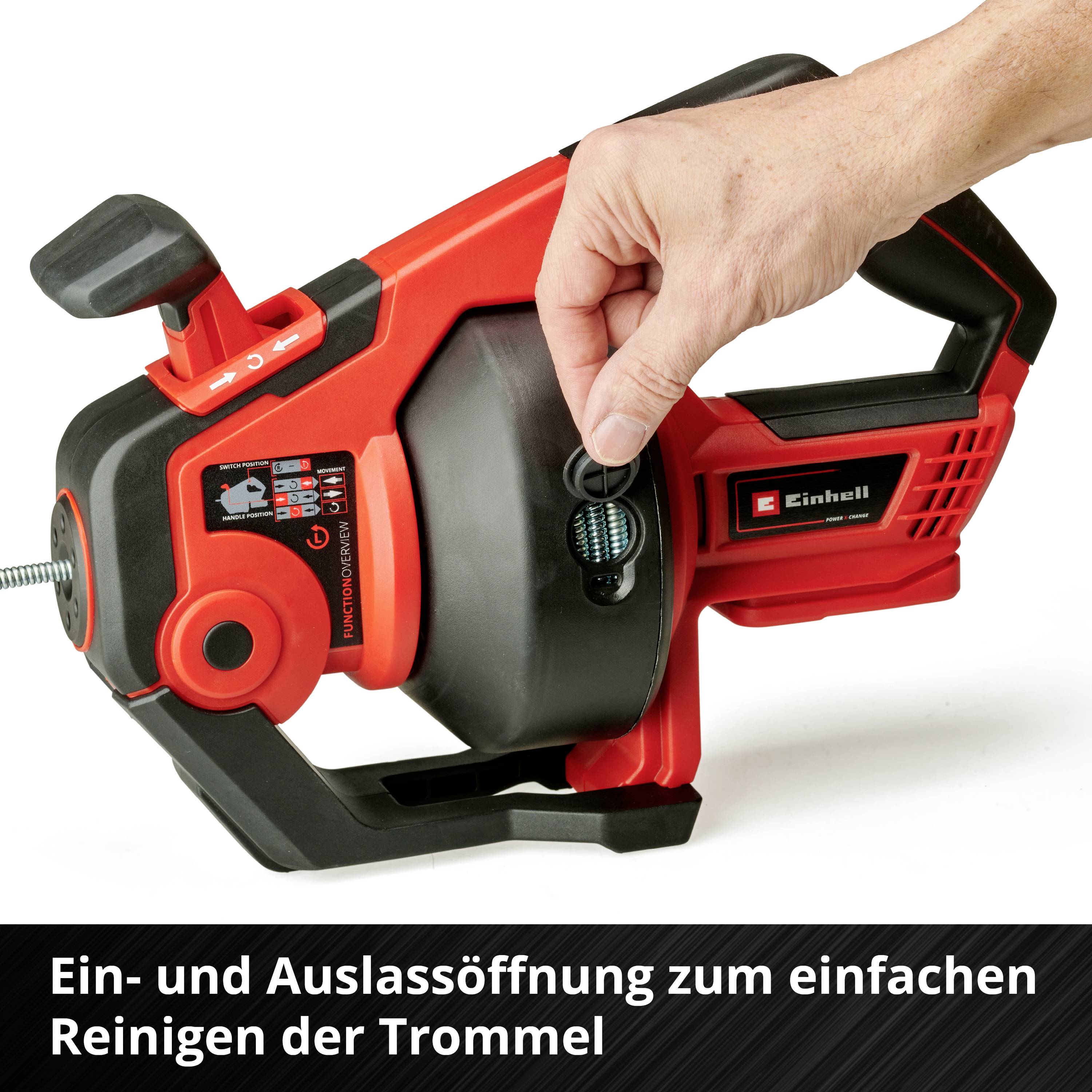 Hand hält eine rote Maschine mit einem drehbaren Zifferblatt und Text 'Ein- und Auslassöffnung zum einfachen Reinigen der Trommel'.