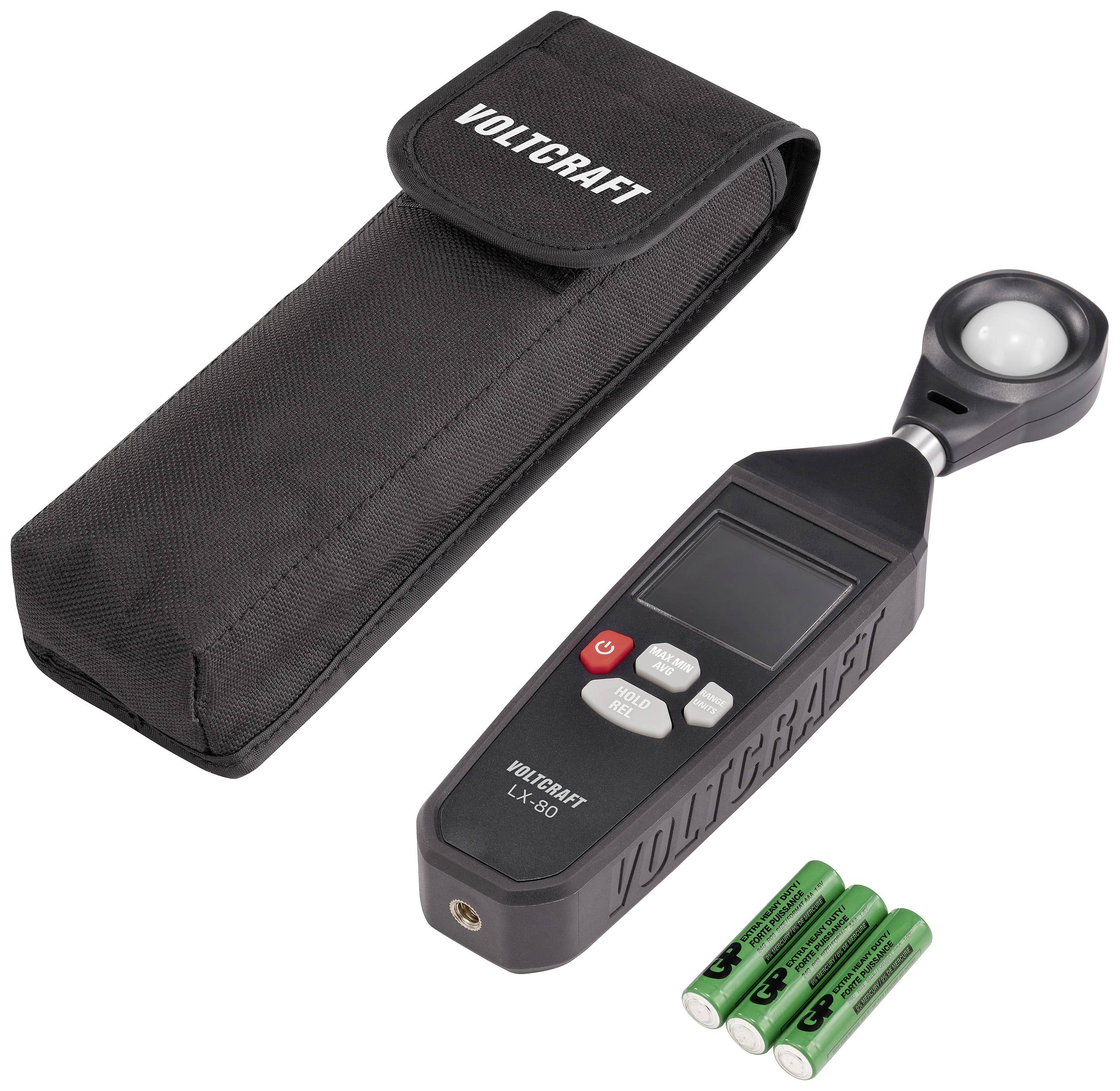 Ein digitales Luxmeter von Voltcraft mit abnehmbarem Sensor, einer schwarzen Tragetasche und vier grünen AA-Batterien.