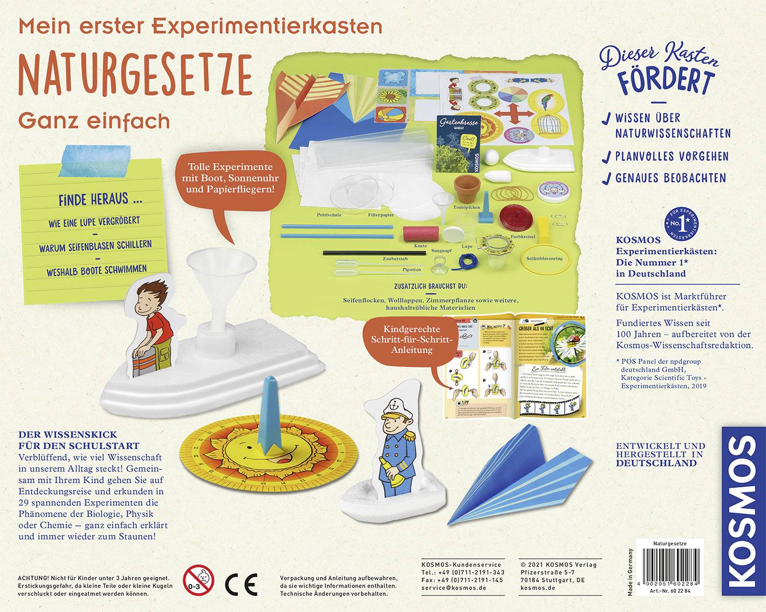 'Mein erster Experimentierkasten Naturgesetze' zeigt Inhalte des Sets: Papierflieger, Trichter, Karten und Zubehör zur Entdeckung physikalischer Prinzipien.