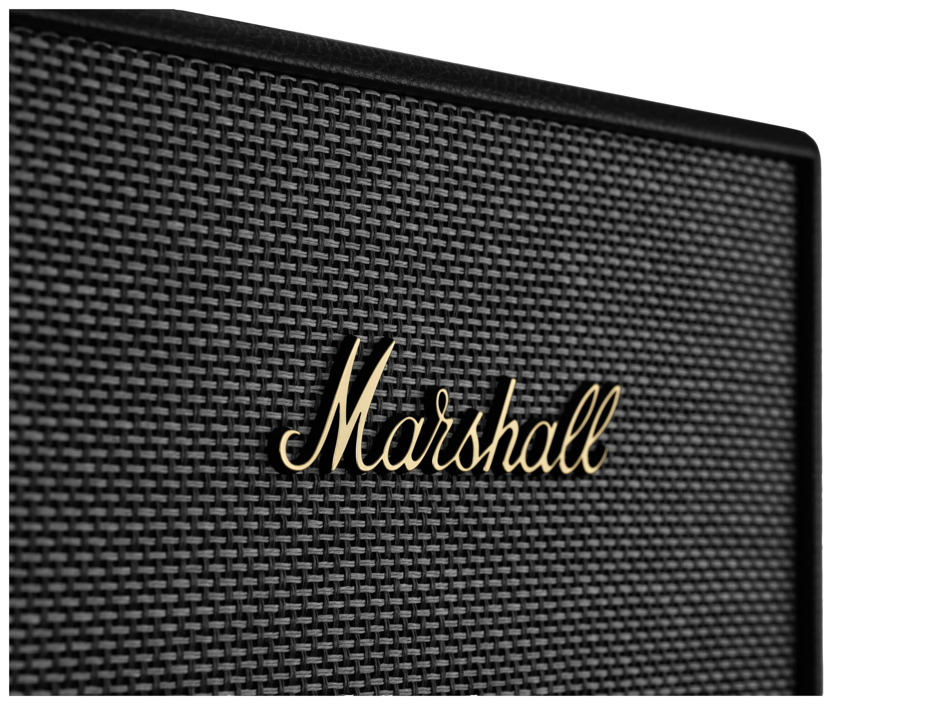 Ein schwarzer Lautsprecher mit goldfarbenem 'Marshall'-Logo auf einem texturierten Gittermuster.