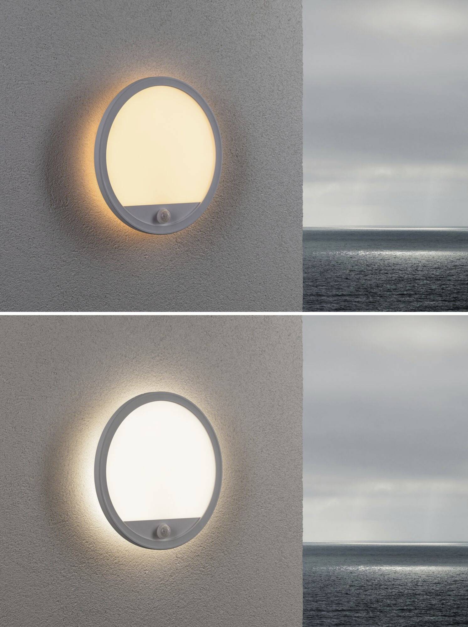 Zwei Wandlampen leuchten unterschiedlich: obere warmes Licht, untere kühles Licht. Im Hintergrund Meerblick, wolkiger Himmel.