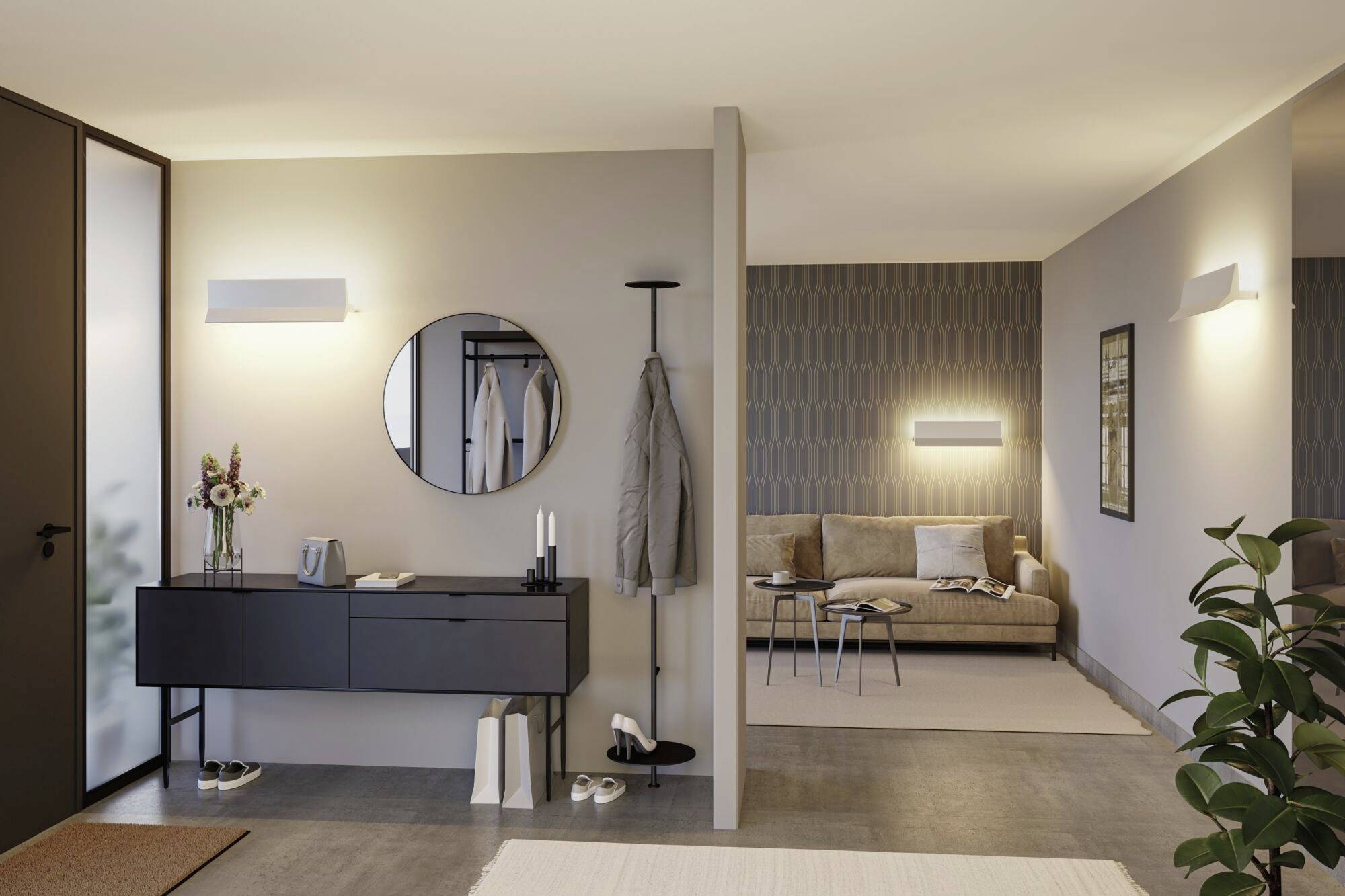 Moderner Eingangsbereich mit einem runden Spiegel, einer schwarzen Konsole und einer Jacke am Haken. Im Hintergrund ist ein Wohnzimmer mit Sofa.