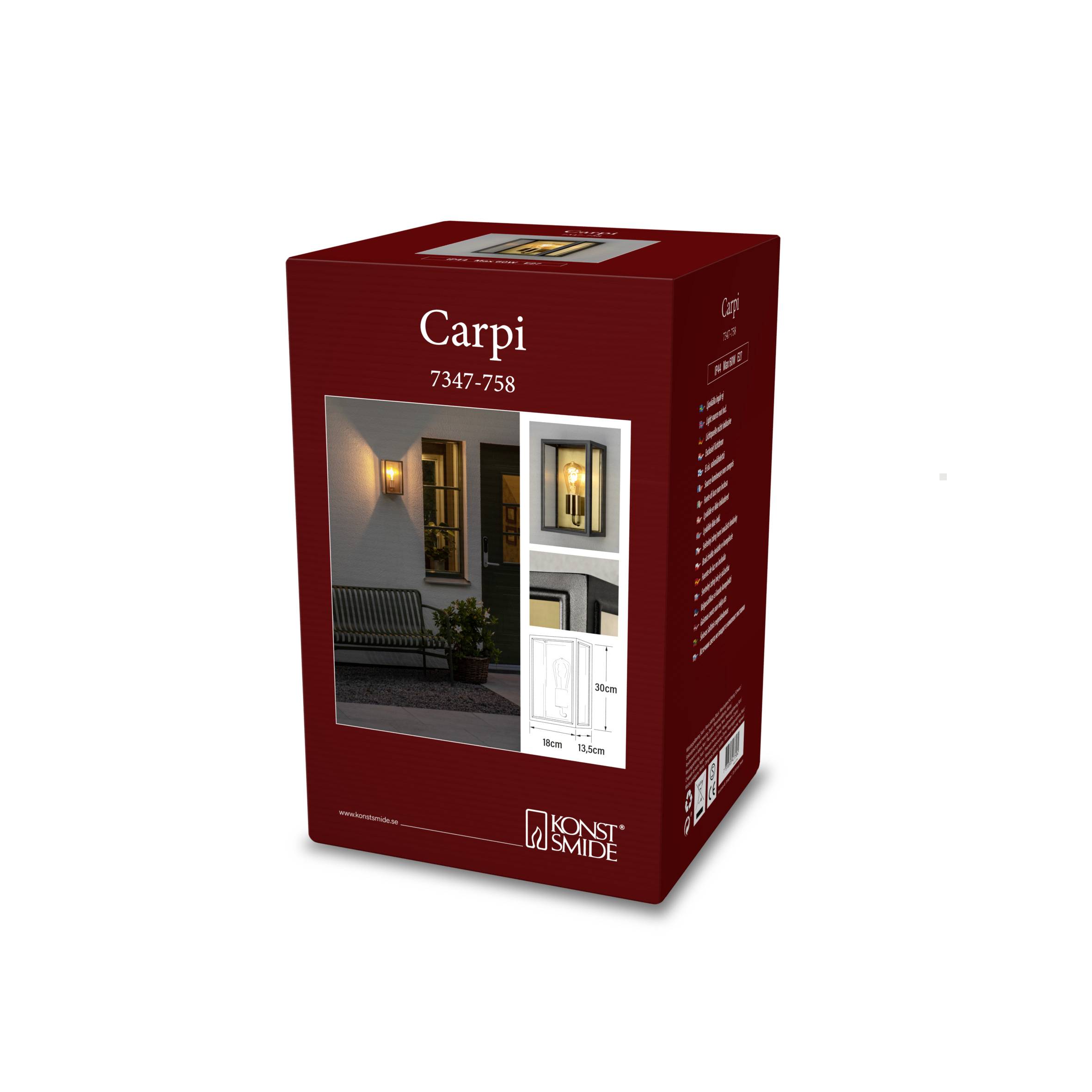 Rote Verpackung einer Außenleuchte 'Carpi 7347-758' von Konstsmide, zeigt beleuchtetes Hausbeispiel und Produktdetails.