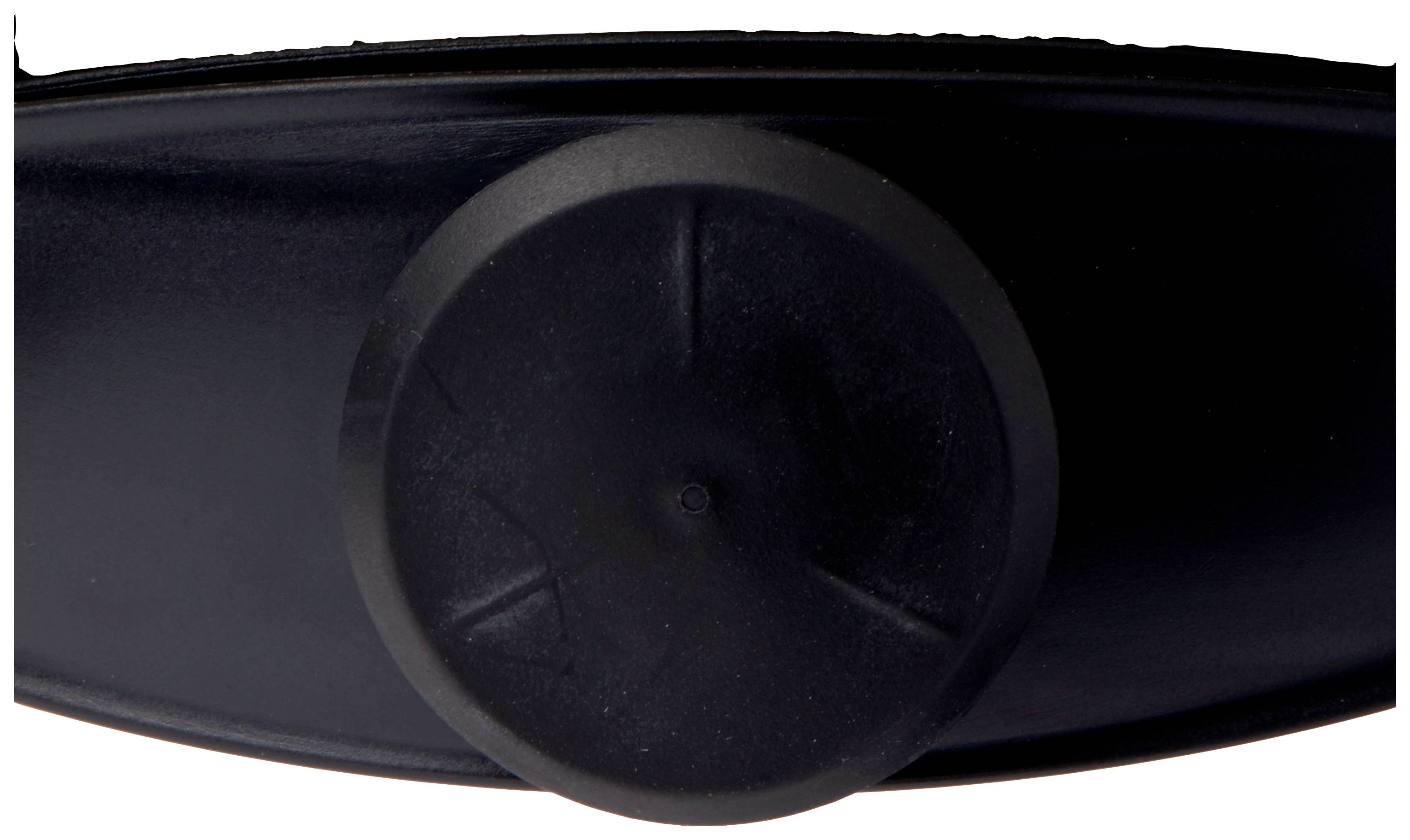 Ein schwarzer, runder Knopf auf einer glatten, schwarzen Oberfläche, möglicherweise Teil eines Geräts oder einer Maschine.