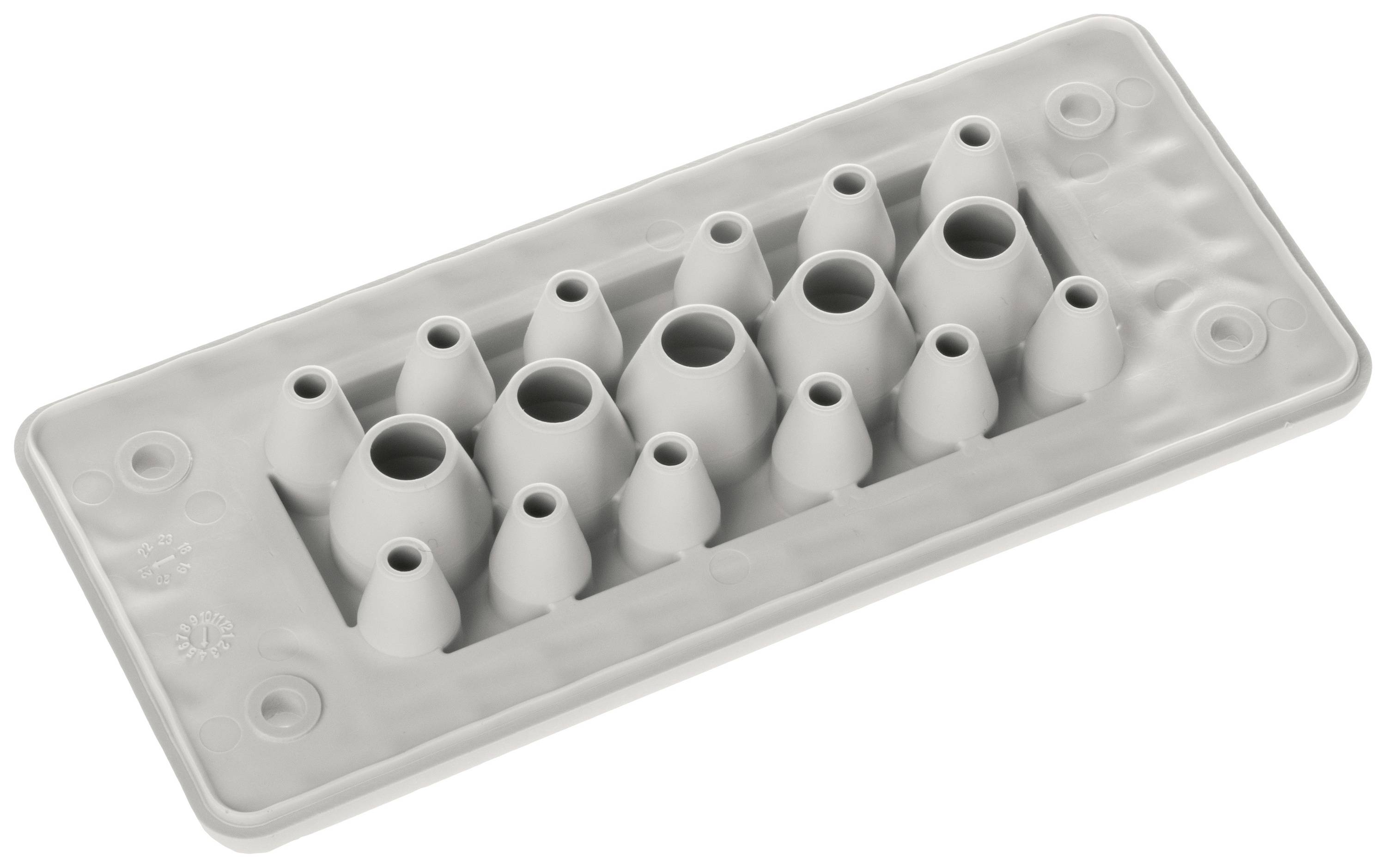 Graues rechteckiges Gerät mit mehreren Öffnungen unterschiedlicher Größe, wahrscheinlich für Kabeldurchführungen oder elektrische Anschlüsse.