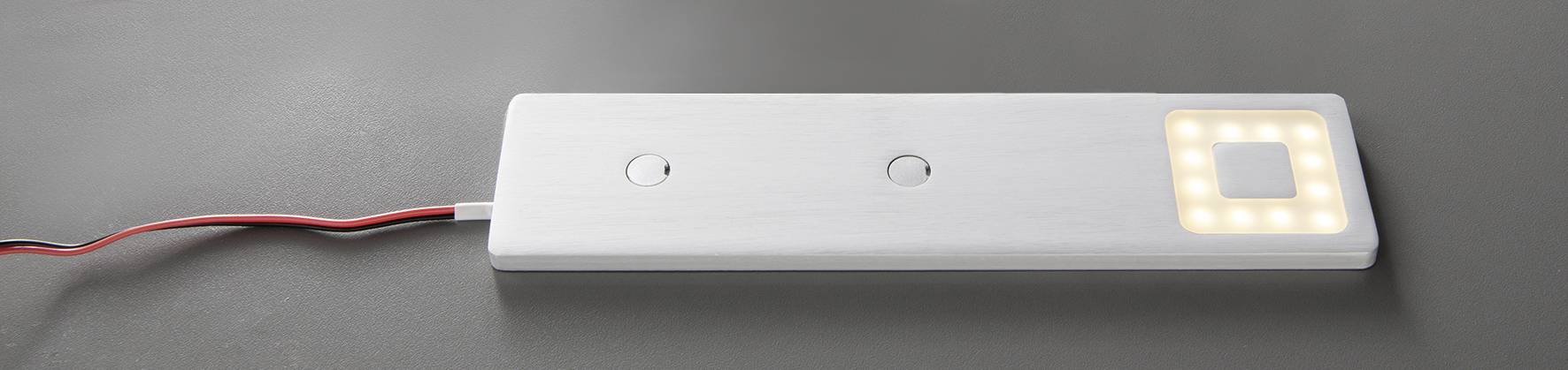 Weißer rechteckiger Sensor mit zwei Knöpfen und integrierter LED-Beleuchtung, zum Beispiel für Möbel.