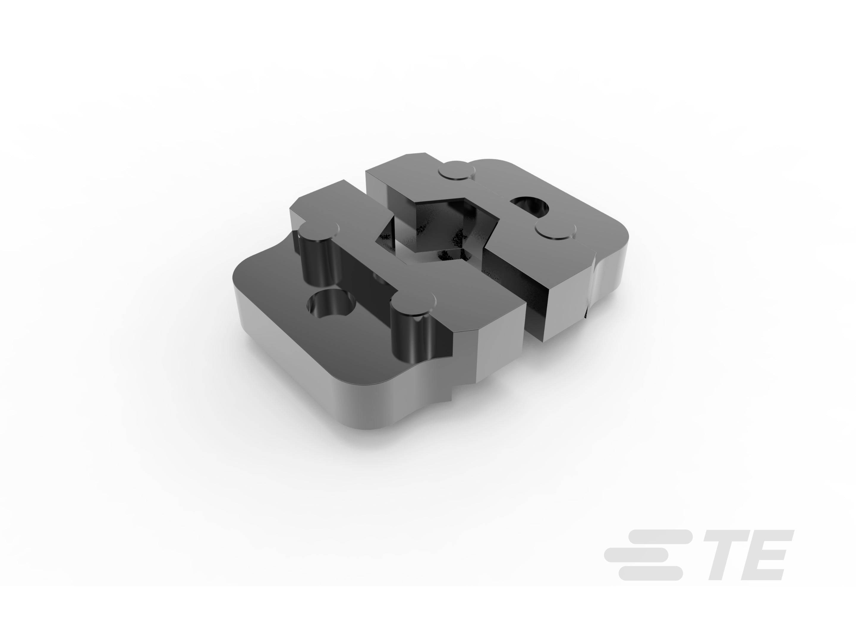 Metallisches Werkzeugteil auf weißem Hintergrund. Werkzeug ist rechteckig, mit mehreren Aussparungen und erhöhten Bereichen. Logo 'TE' in der unteren rechten Ecke.