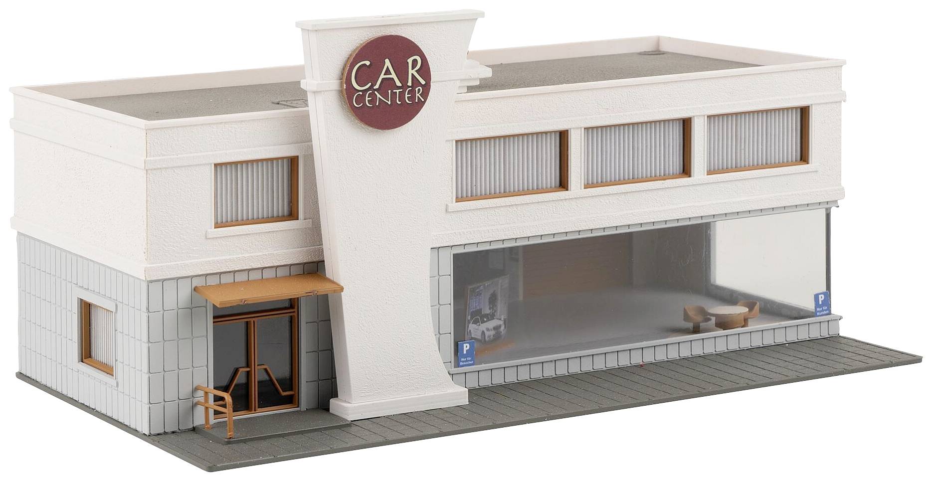Modell eines Autohauses mit der Aufschrift 'Car Center' über dem Eingang und großen Schaufenstern an der Vorderseite.