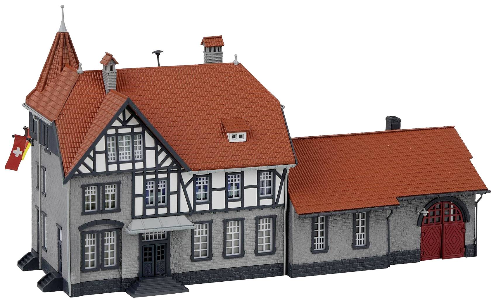 Graues Fachwerkgebäude mit rotem Ziegeldach, vier Schornsteinen und Schweizer Flagge an der Fassade. Historischer Baustil.