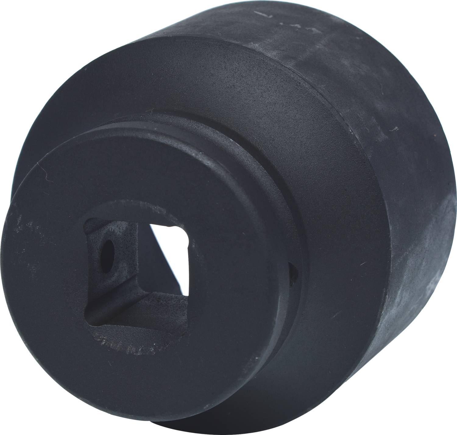 Schwarzes Metallteil in zylindrischer Form mit einer quadratischen Öffnung in der Mitte, möglicherweise ein mechanisches Bauteil.