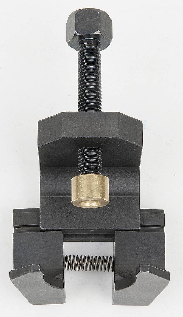 Metallischer Schraubstock mit schwarzer Schraube und goldener Mutter, verwendet zum Befestigen von Werkstücken.