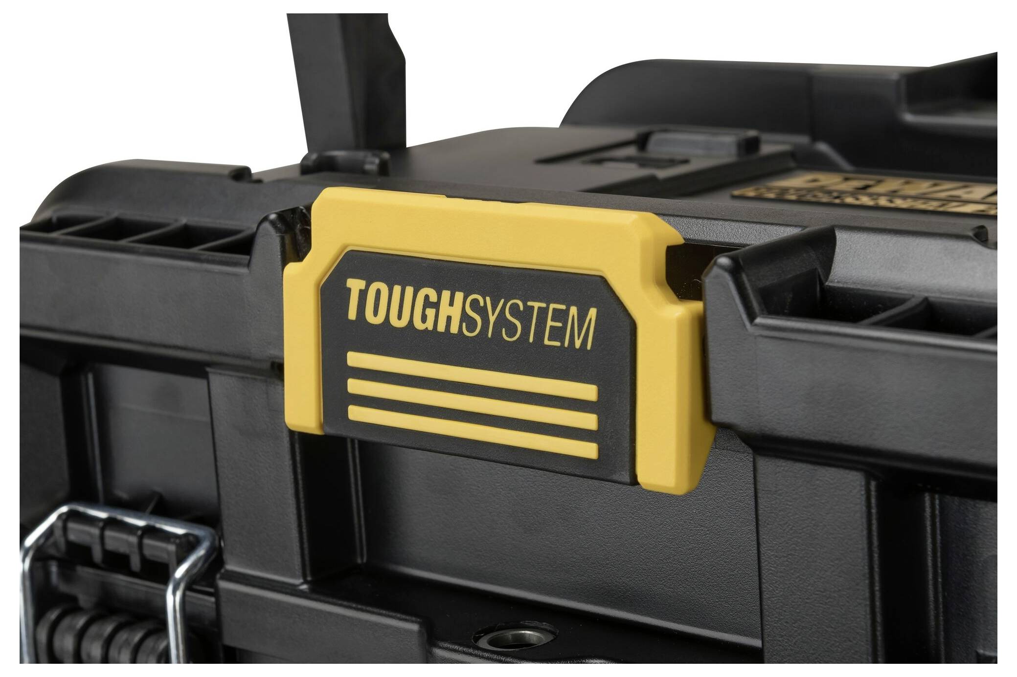 Schwarze Werkzeugkiste mit gelbem Griff mit der Aufschrift 'TOUGHSYSTEM'. Sie ist robust und für industrielle Anwendungen geeignet.
