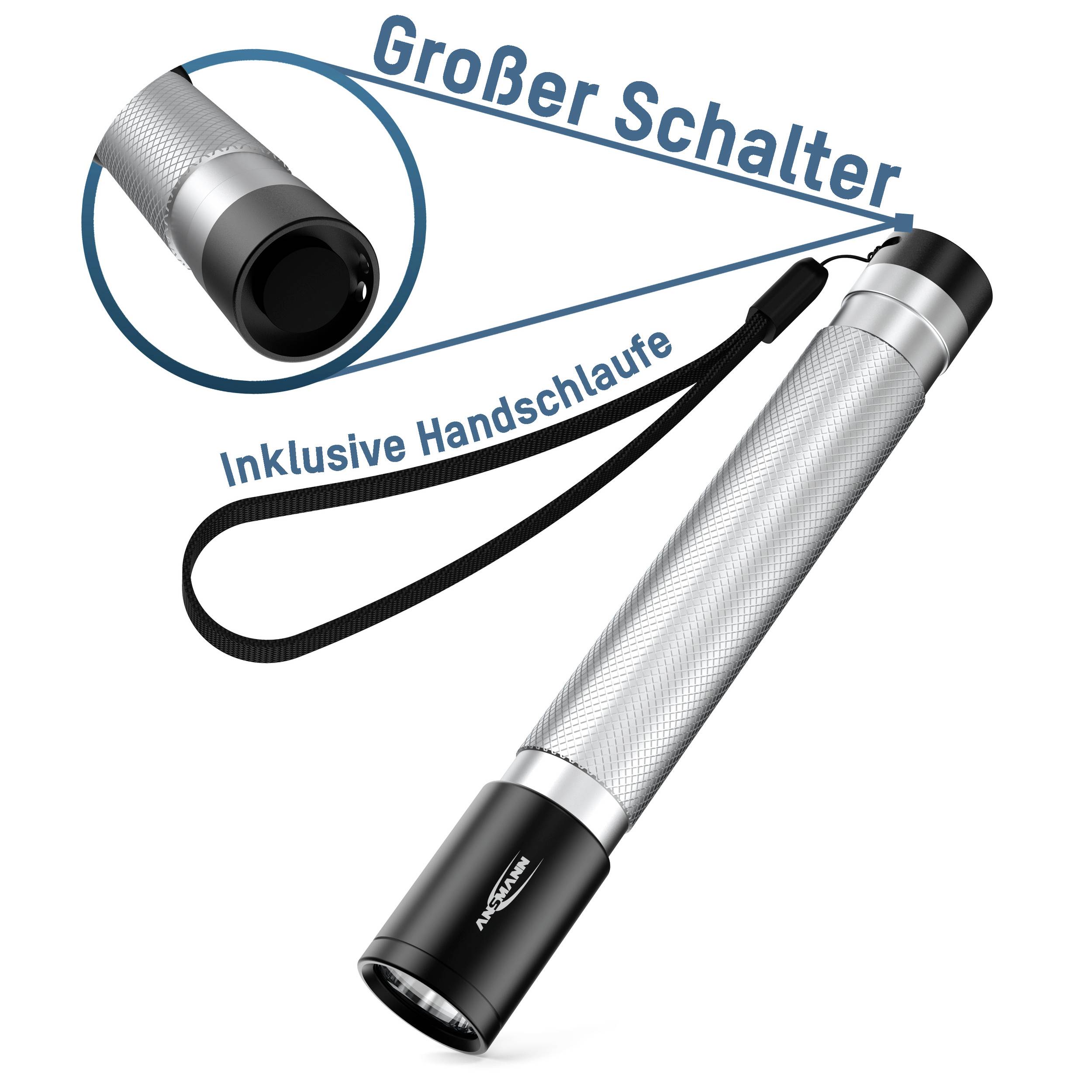 Taschenlampe mit großem Schalter, silbernem Gehäuse und Handschlaufe. Text: 'Großer Schalter', 'Inklusive Handschlaufe'.