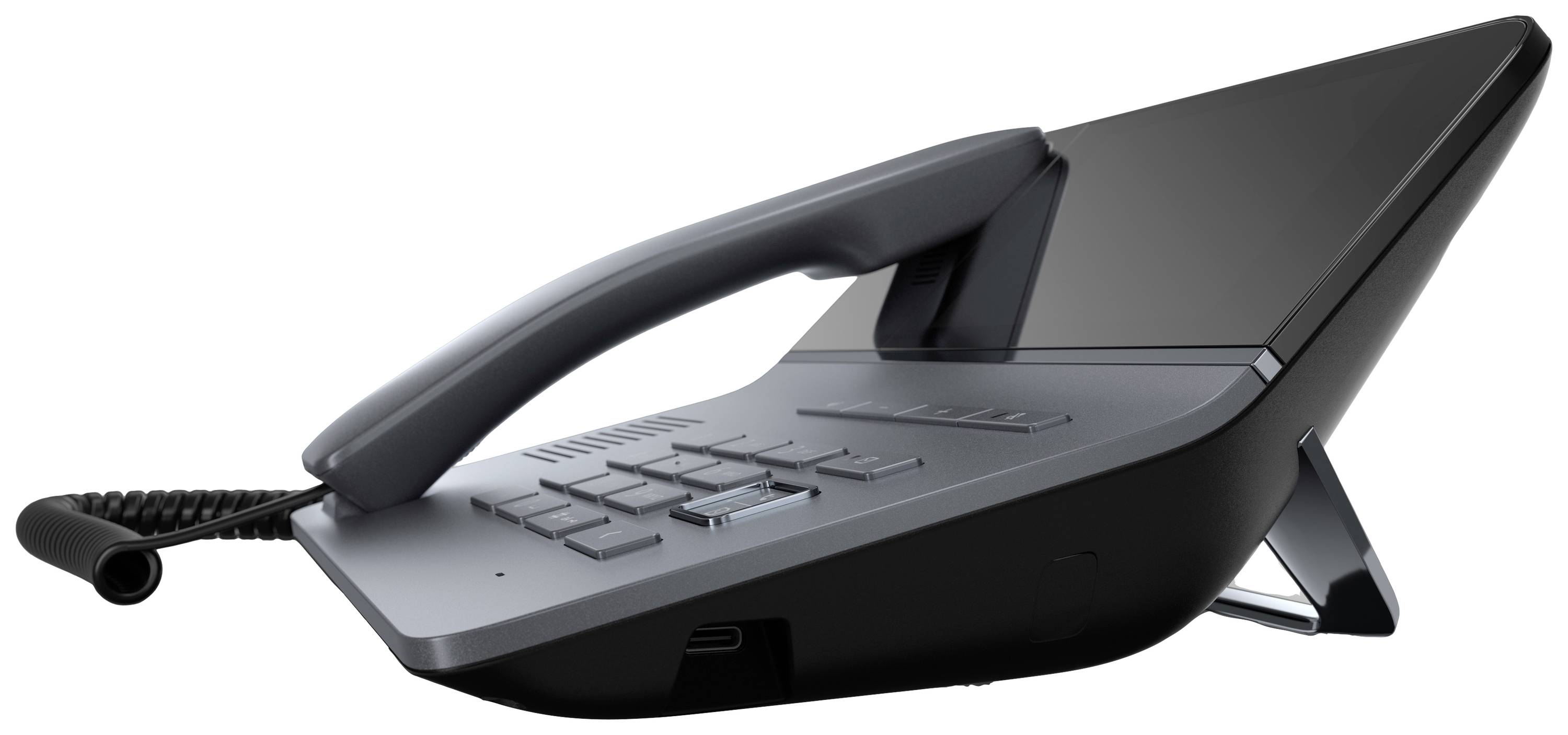 Ein modernes, schwarzes Bürotelefon mit Lautsprecher und Display, seitliche Ansicht. Appartement auf einem Schreibtisch platziert.