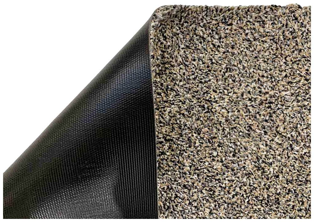 'Nahaufnahme einer zweifarbigen Matte: links schwarzer, strukturierter Untergrund; rechts braune, gemusterte Oberfläche.'