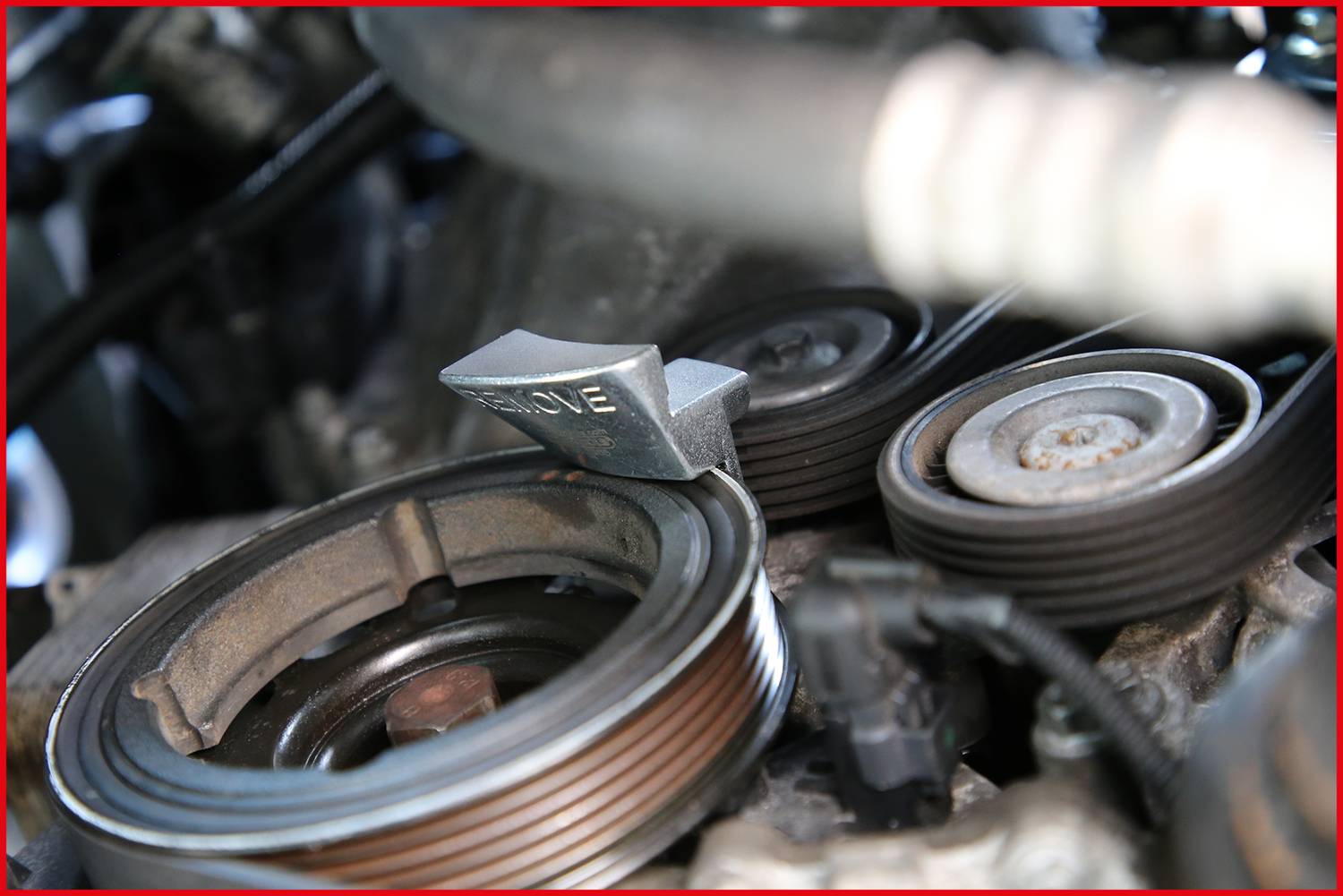 Ein Motor mit mehreren Rillenriemen und einer Metallplatte im Vordergrund, die das Wort 'DIESEL' zeigt.