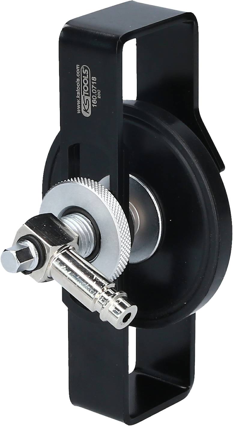 Ein schwarzes Metallteil mit einer zahnradähnlichen Scheibe und einer Schraube in der Mitte, vermutlich ein Mechanismus oder Werkzeug.