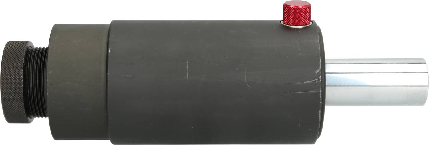 Ein zylindrisches, schwarzes Hydraulikventil mit rotem Knopf und silbernem Auslass auf weißem Hintergrund.