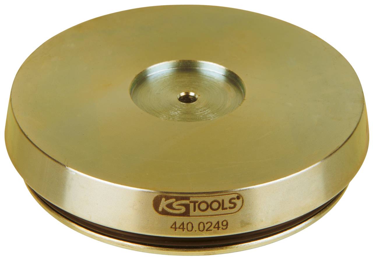 Ein Metallwerkzeug mit der Aufschrift „KS TOOLS 440.0249“ in der Mitte. Es hat eine flache, runde Form und eine glänzende Oberfläche.